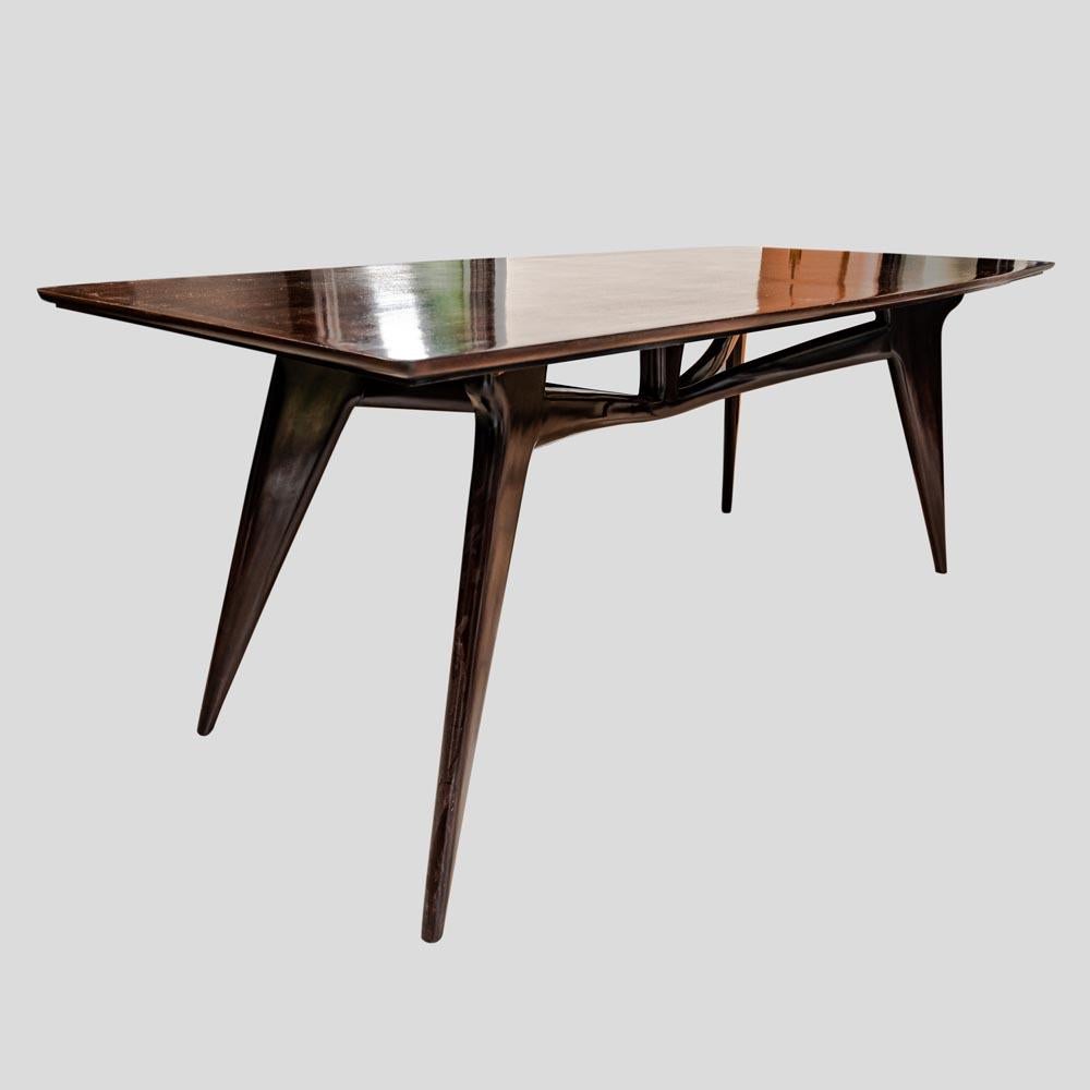 Italian craftsmanship shines in this exquisite dark brown polished mahogany dining table, believed to be associated with the renowned designer Ico Parisi from the early 1950s. A testament to the organic modernist movement that defined Italian