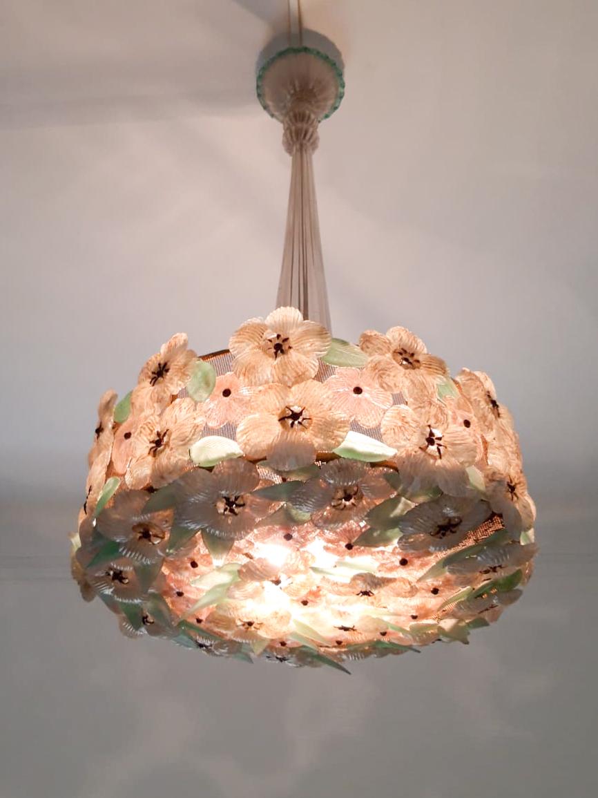 This mid-century colored glass floral motif Murano chandelier, incredibly sought after and highly coveted. It is an exceptionally rare model, featuring a breathtaking display of diverse and exquisite flowers. The chandelier is crafted with a sturdy