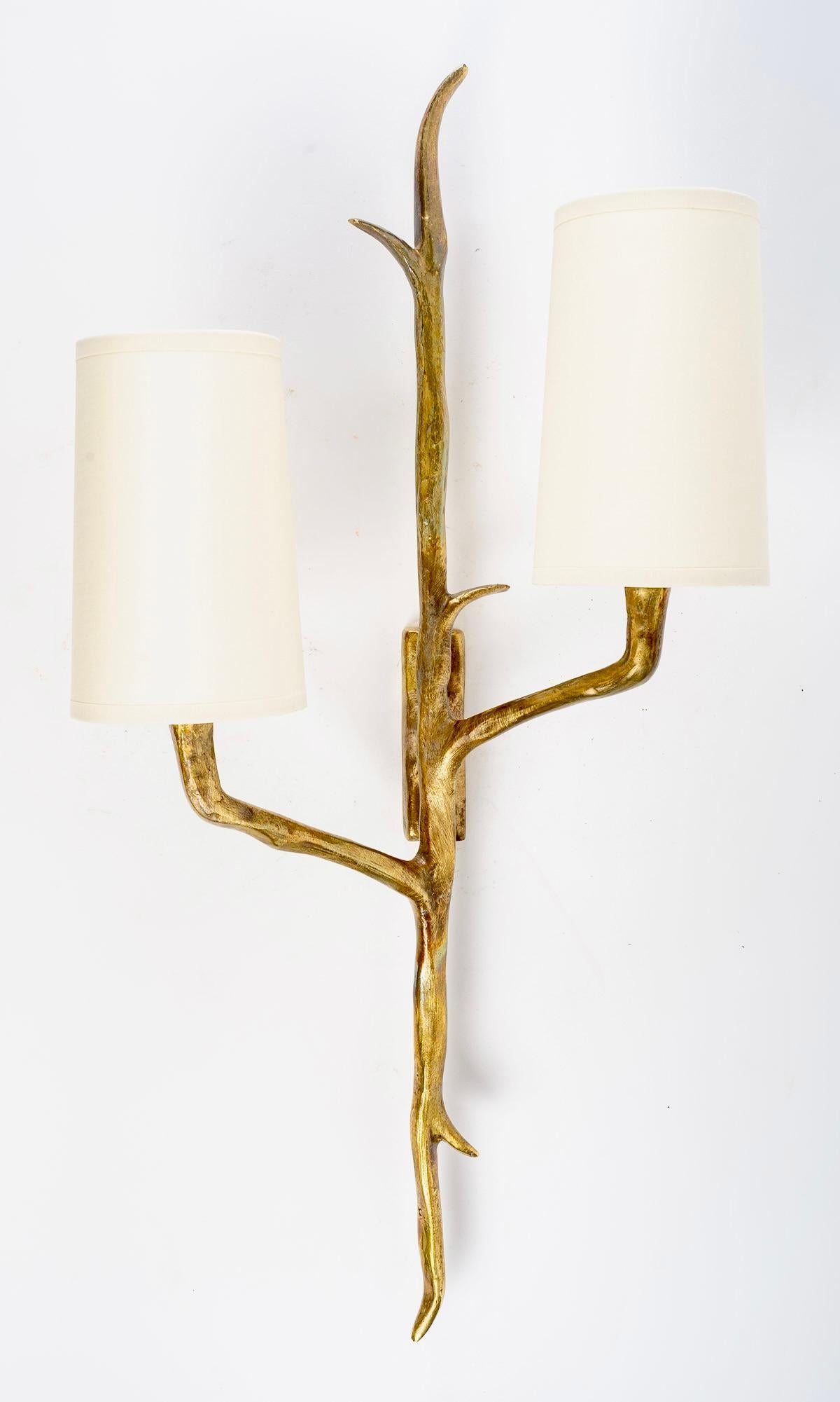 1950 large pair of sconces in bronze Félix Agostini for Arlus 
Composed of a central arm in the shape of a branch decorated with two small branches forming the two arms of light placed on either side of the central arm positioned at two different