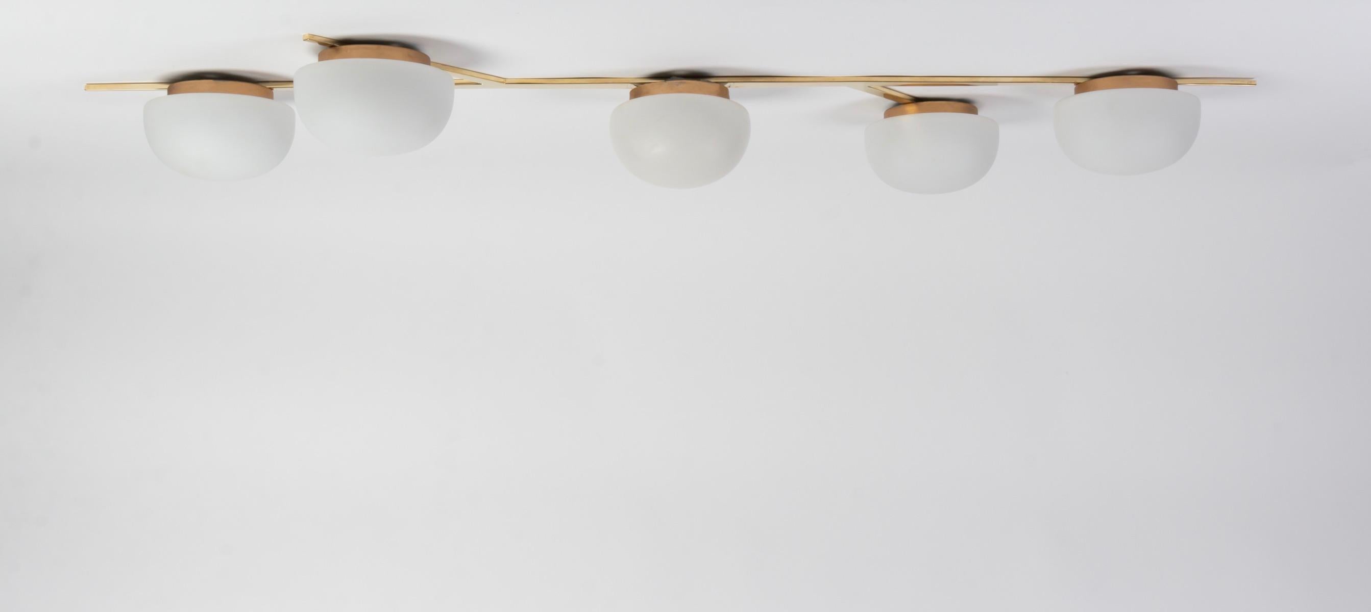 1950s large Lunel light. Can be hang as ceiling light or as wall light.
The frame figures a stylized branch made of brass and features 5 round opalin glass diffusers.
 