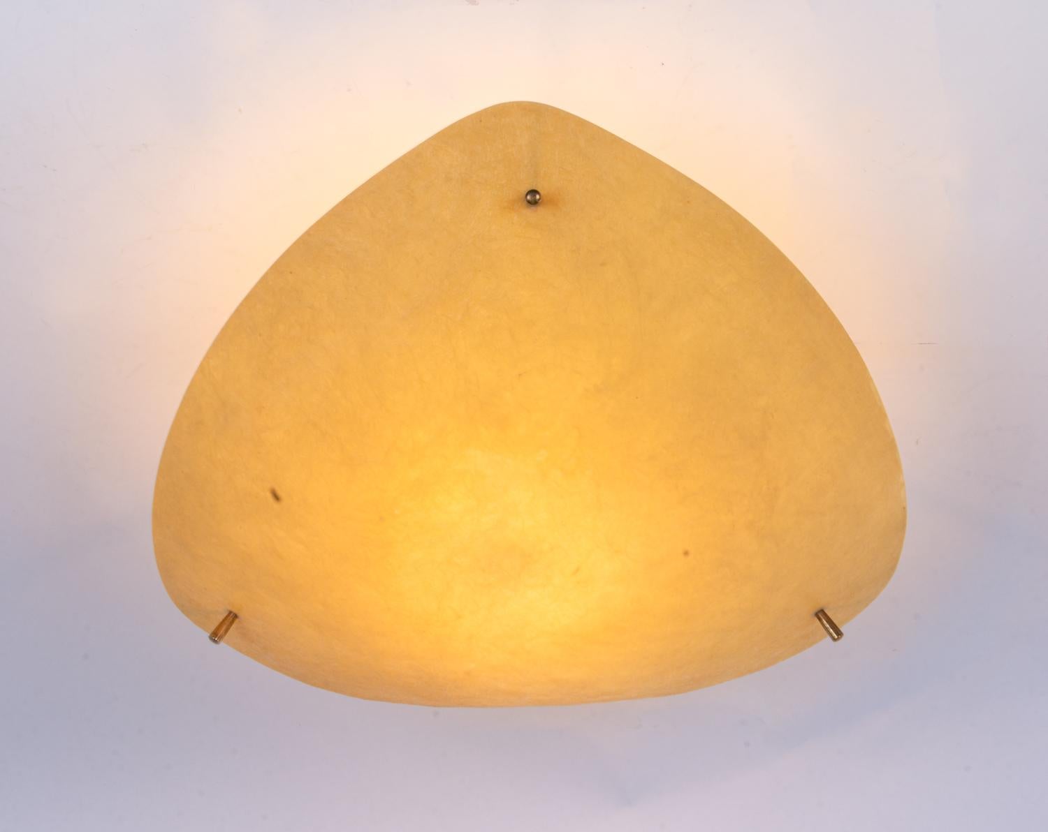 Minimalistic flying saucer flush mount with a yellow fiberglass shade on a metal frame with brass finals. The lamp is designed and created in Austria or in the 1950s. 

Style: Mid-Century Modern, Minimalist. 
Materials: fiberglass, brass and metal.