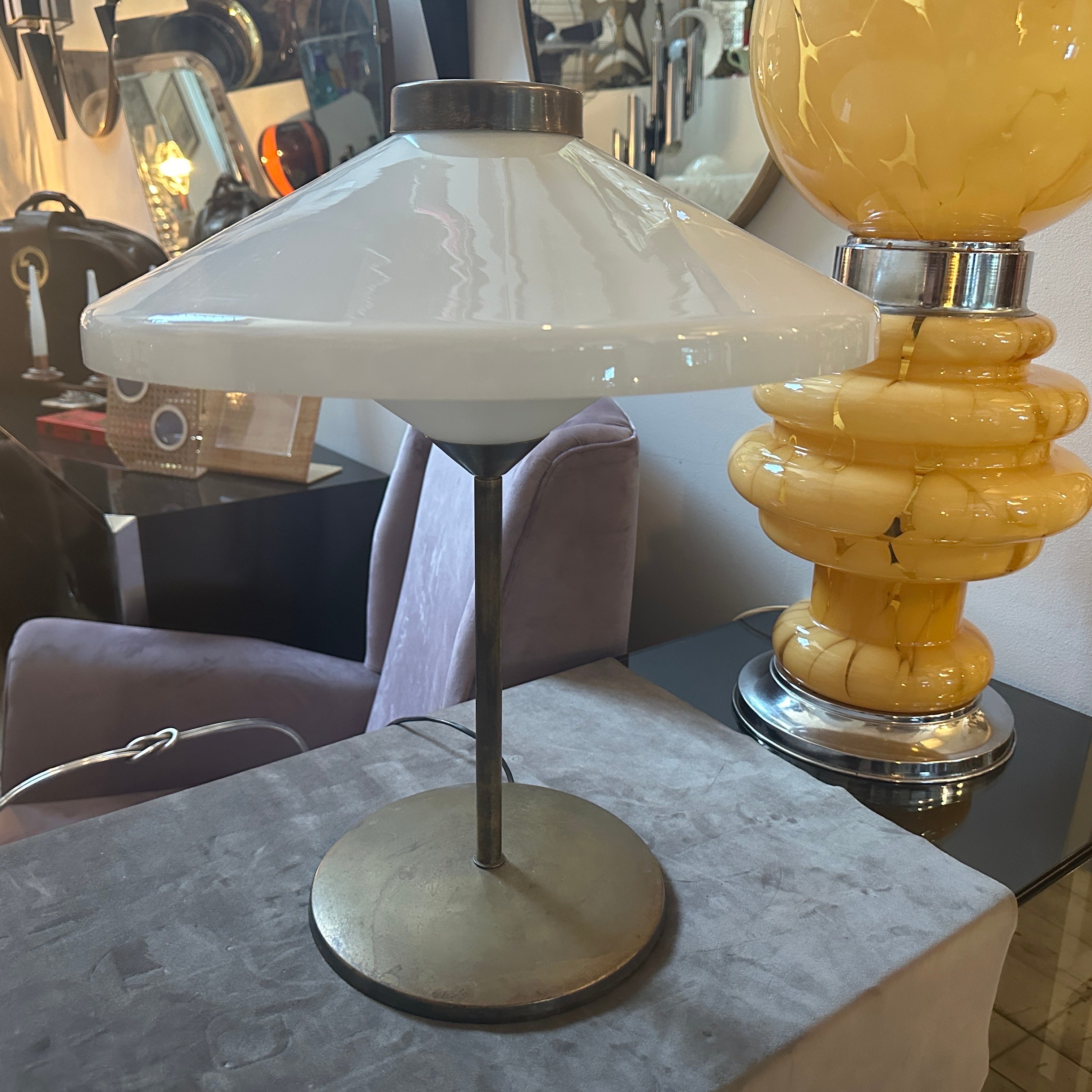 This is a 1950s Italian table lamp in the Mid-Century Modern style, inspired by Oscar Torlasco. The lamp reflects the sleek, minimalist, and functional design ethos characteristic of Mid-Century Modern aesthetics, Its form is elegant, with clean