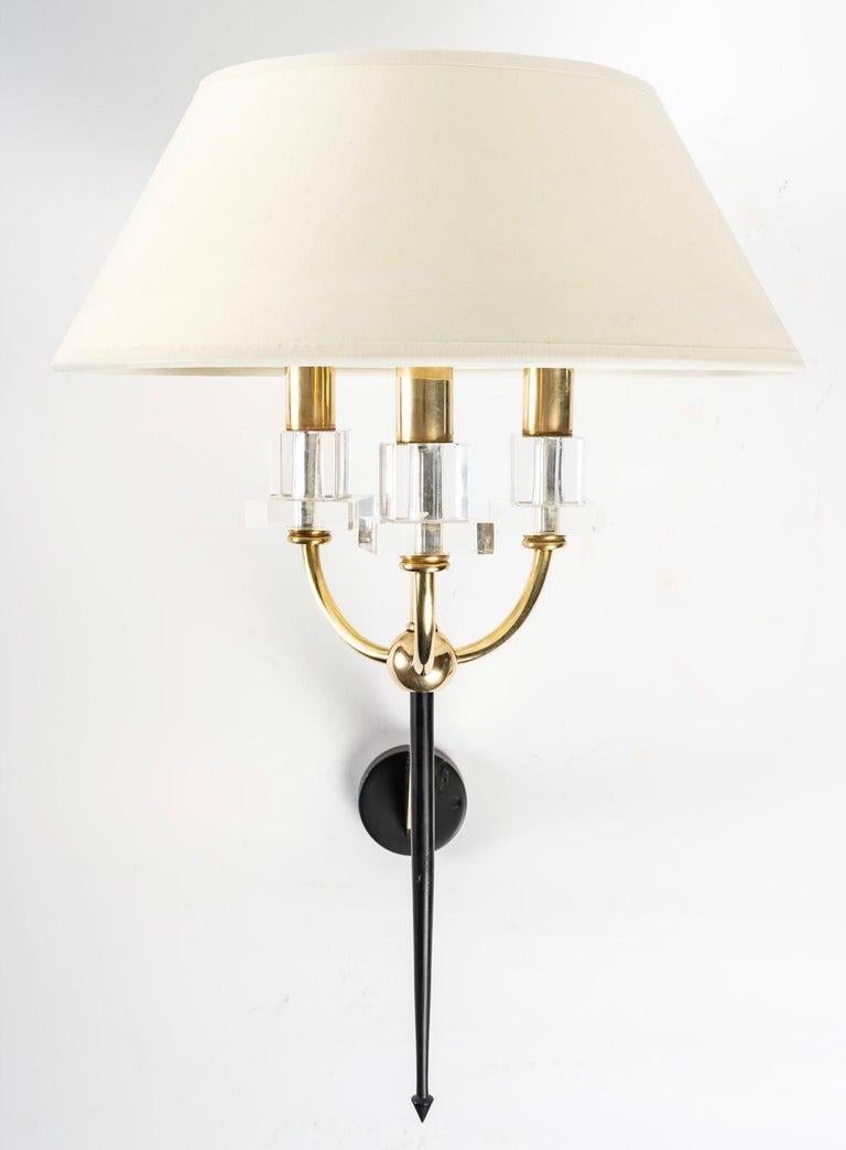 1950 Pair of Marcel Asselbur sconces
Elegant pair of Marcel Asselbur sconces, 1950s.

Composed of a round wall support in blackened brass on which is placed an arm in gilded brass.
The body of the sconce is placed on the gilded brass rod, it is