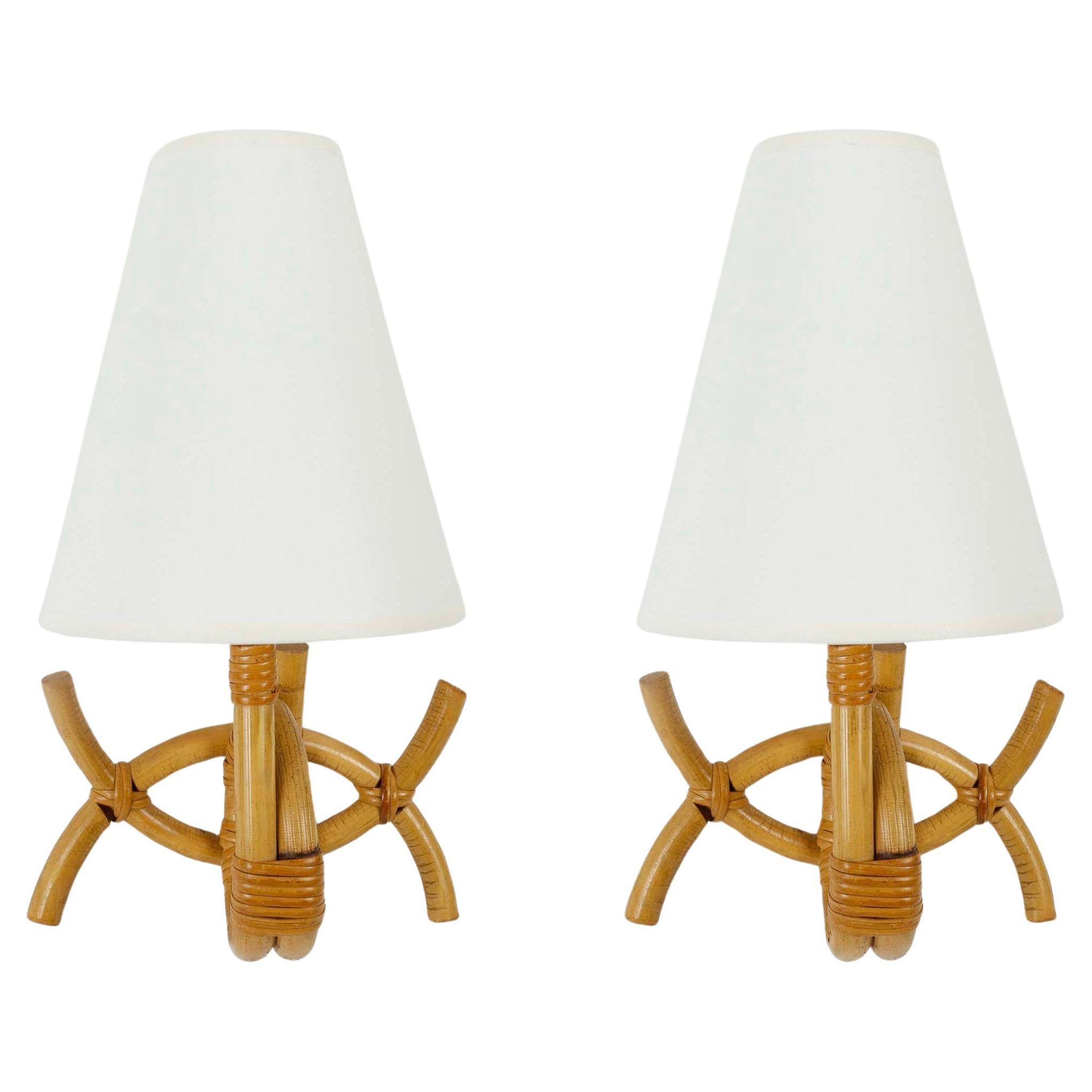 1950 Pair of rattan wall lamps by Louis Sognot For Sale
