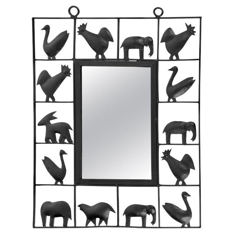 Wrought-iron animal mirror by Atelier Marolles, France, 1950s. 

Composed of a wrought-iron frame with brown patina decorated with an animal bestiary inspired by the farmyard and the savannah.
hen, rooster, duck, elephant etc...
An original mirror