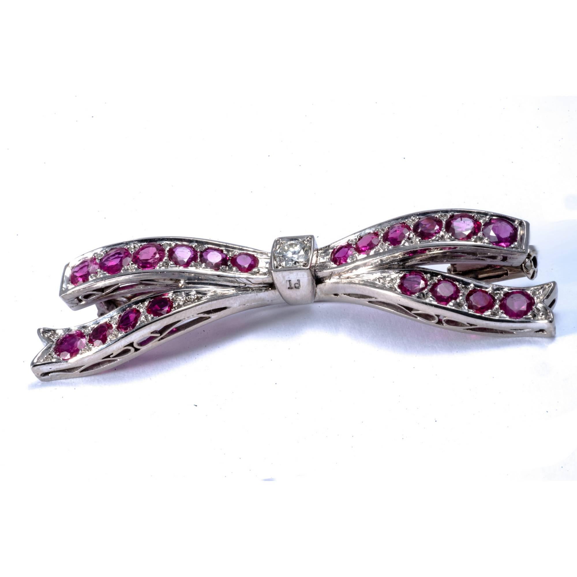 The ribbon bow, one of the favorite ornamental motifs from earlier centuries, became even more popular in the 1950's decade. This pin brooch, fully hand made in platinum, exemplifies the elegant attitude of the period and can be wore as a necklace