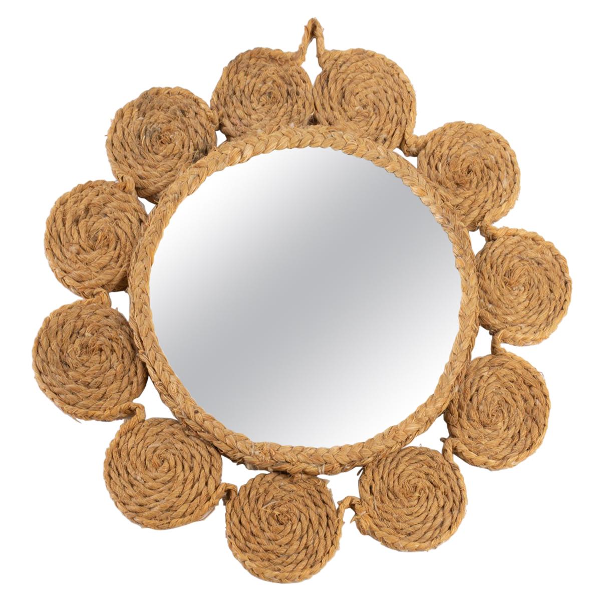 Round mirror dressed in an entourage of rope sewn together forming small circles nicely marrying the environment of the mirror.

Adrien Audoux and Frida Minet are known for their rope lights and furniture. Their first workshop has been founded in