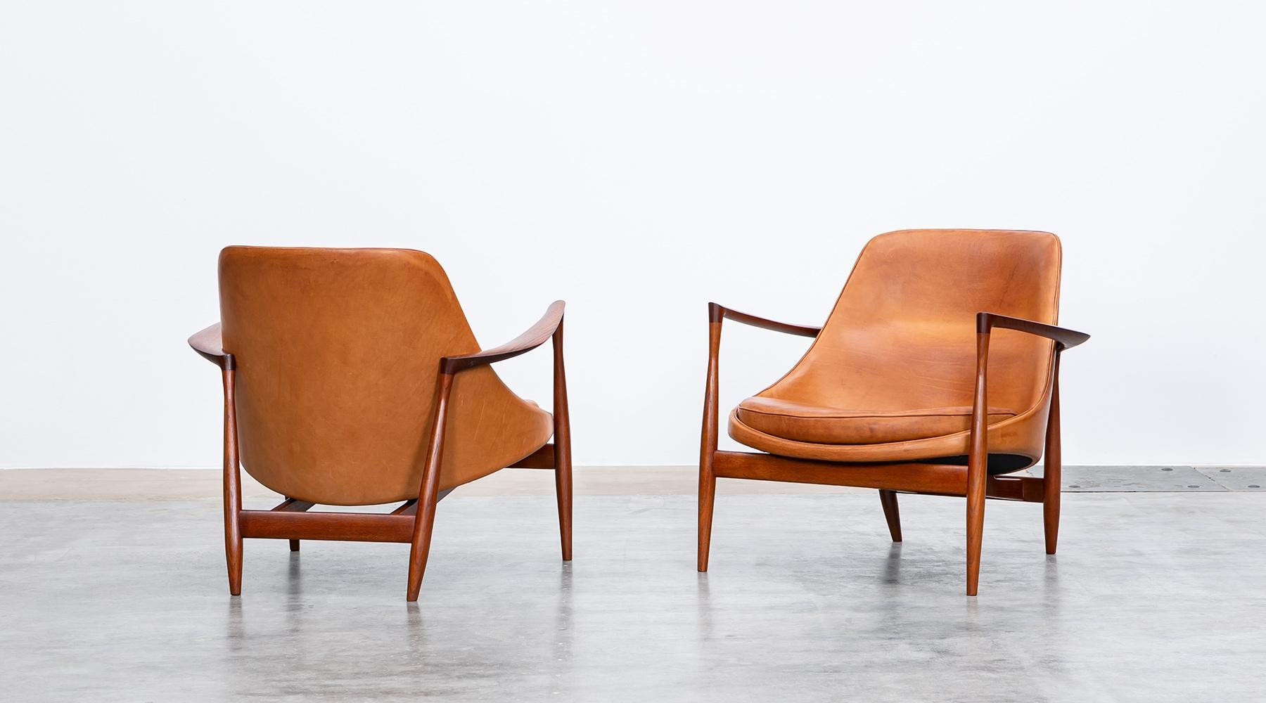 Matching pair of lounge chairs, teak, leather, Denmark, 1956.

Wonderful examples of Ib Kofod-Larsen lounge chairs in teak with amazing patinated cognac leather. The lounge chairs were created in 1956 and are in perfect condition. Manufactured by