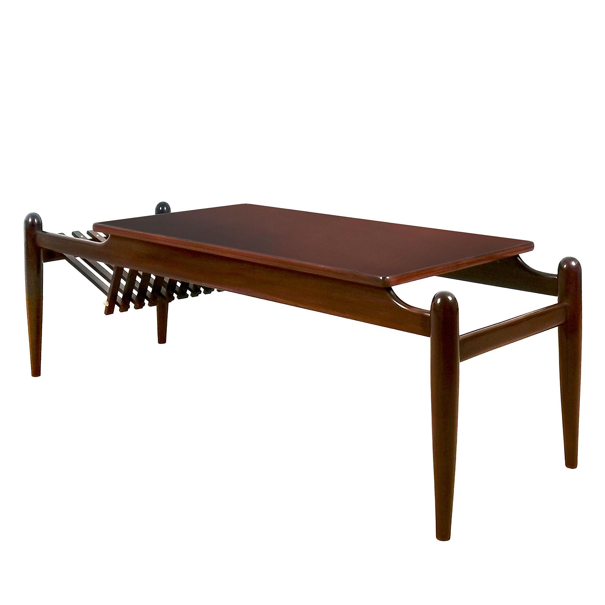 Coffee table with magazine rack, solid mahogany, French polish. Polished brass hardware.
Stamped: GP

Italy c. 1950 

Measurement: top of the table 80 x 45 cm.