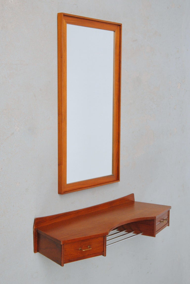 1950´s Fully Restored Danishteak toilet set with floating table top and mirrors

Rare Danish inventive and imaginative teak toilet set / vanity set consisting of floating teak table with drawer, a small hidden mirror and polished metal pipes for