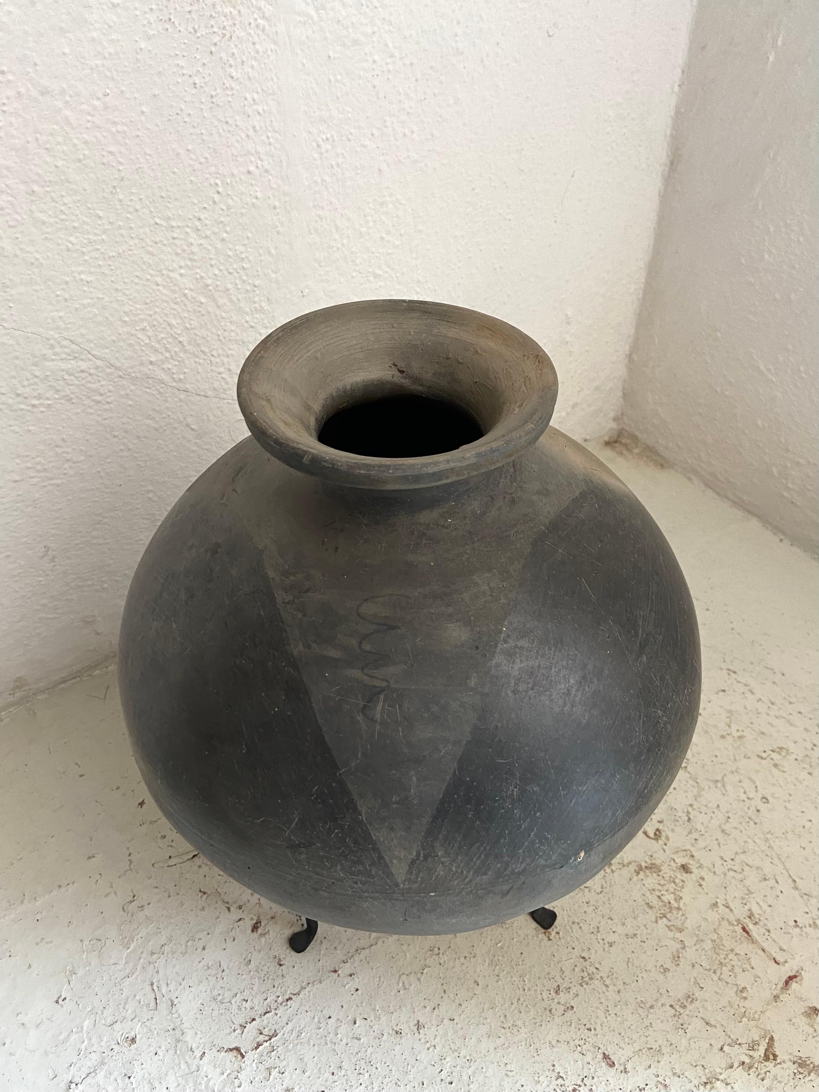 1950´s mezcal ceramic jar from San Bartolo Coyotepec, Oaxaca. Originally used for transporting mezcal by way of donkey, these ceramic jars typically have peak like designs drawn on them. The type of black clay that is used is only accessible in that
