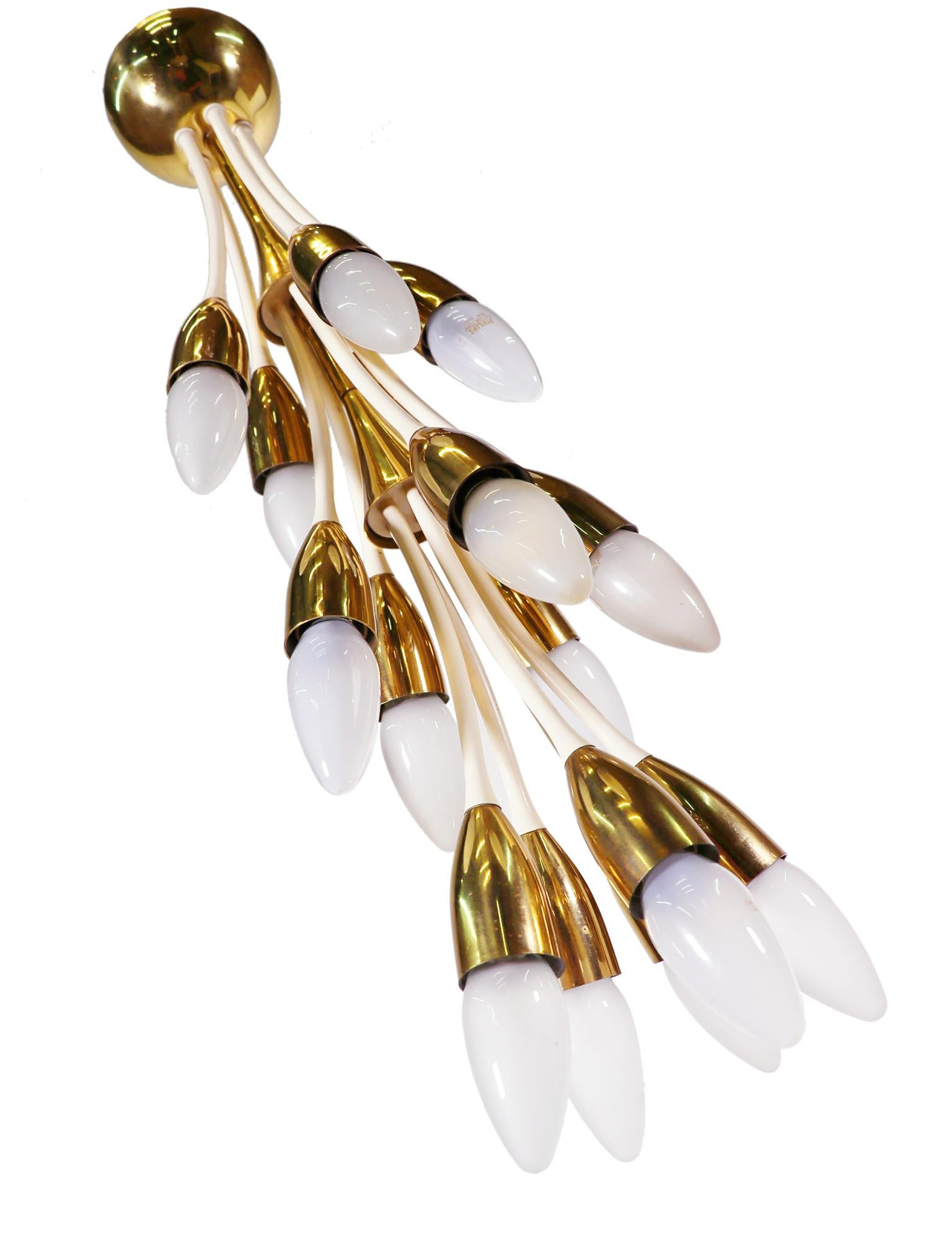 Impressive midcentury twelve-light chandelier with enamel curved arms and polished brass cones, attached to a flushed canopy mount. 
Manufactured by Vereinigte Werkstätten Munich in Germany in the 1950s. 

Lighting: takes twelve small Edison E14