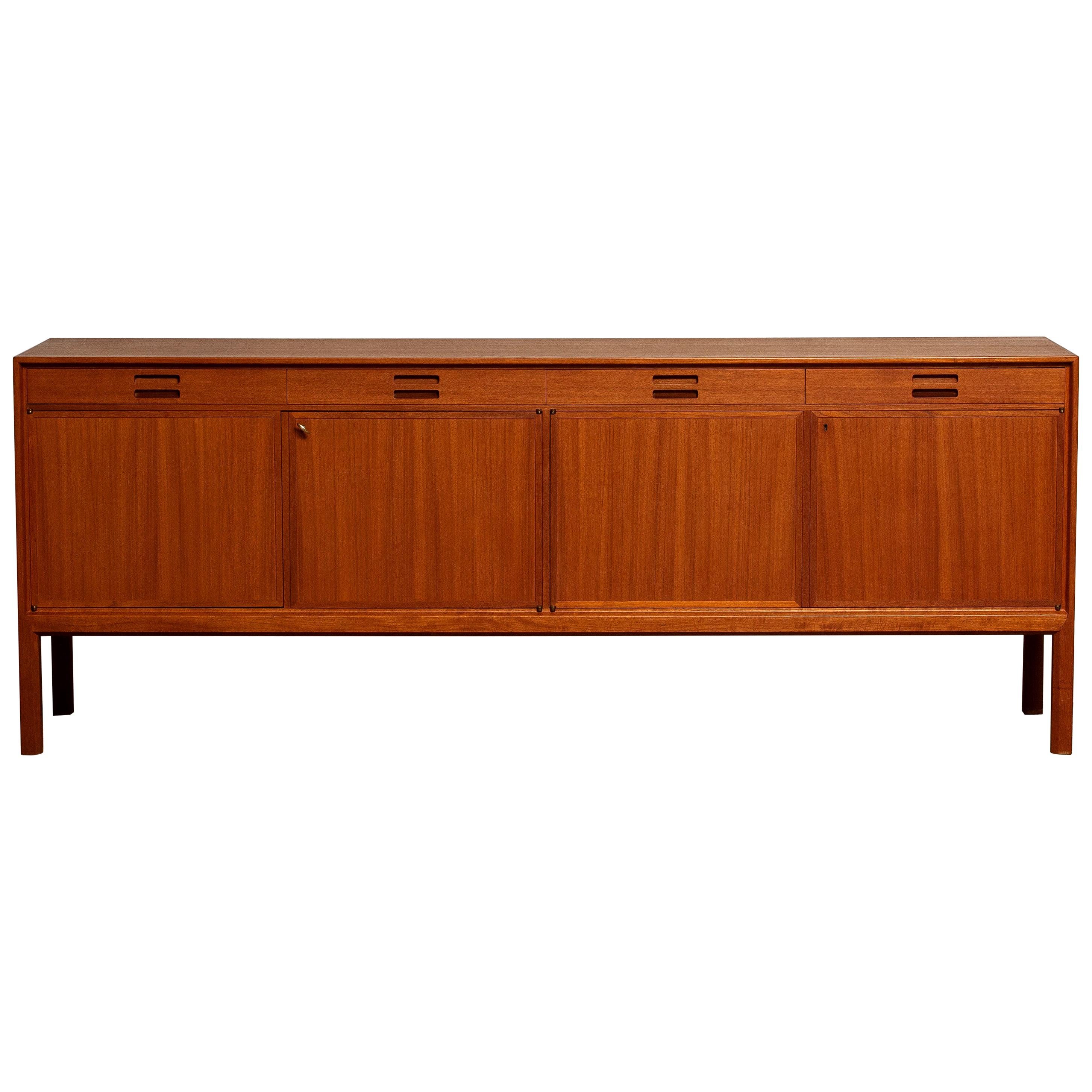 Beautiful sideboard or credenzas designed by Bertil Fridhagen for Bodafors Bra Bohag, Sweden. This sideboard cabinet is made of teak and consist of four drawers and four doors with adjustable shelfs inside. It is in an excellent condition. Period