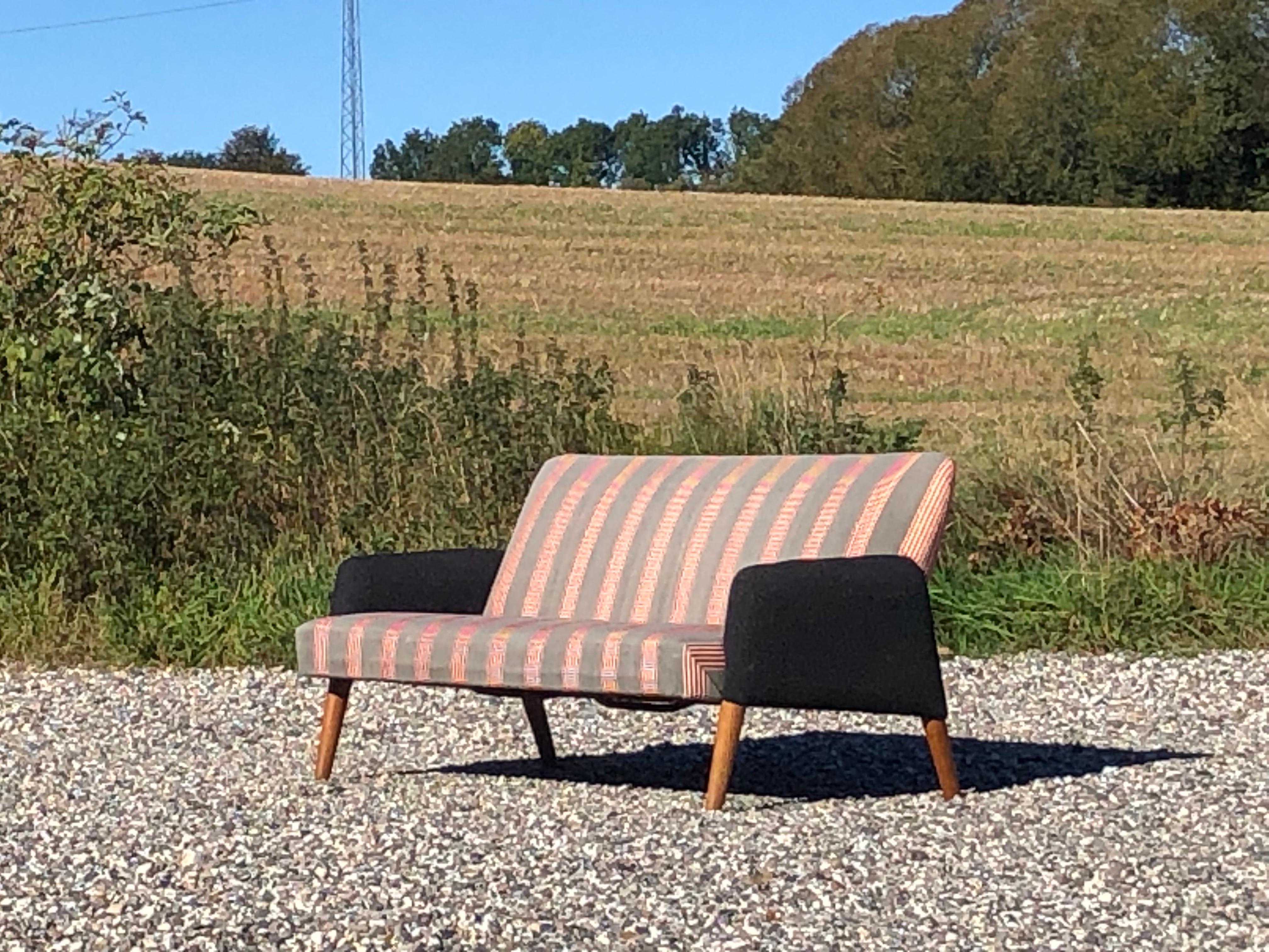 A beautiful 1950ties Danish sofa with oak legs and original fabric. Designed by Danish architect Poul Volther and made and with stamp from Frem Røjle. 