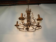 1950, travail italien, lustre en fer forgé doré et laqué noir.