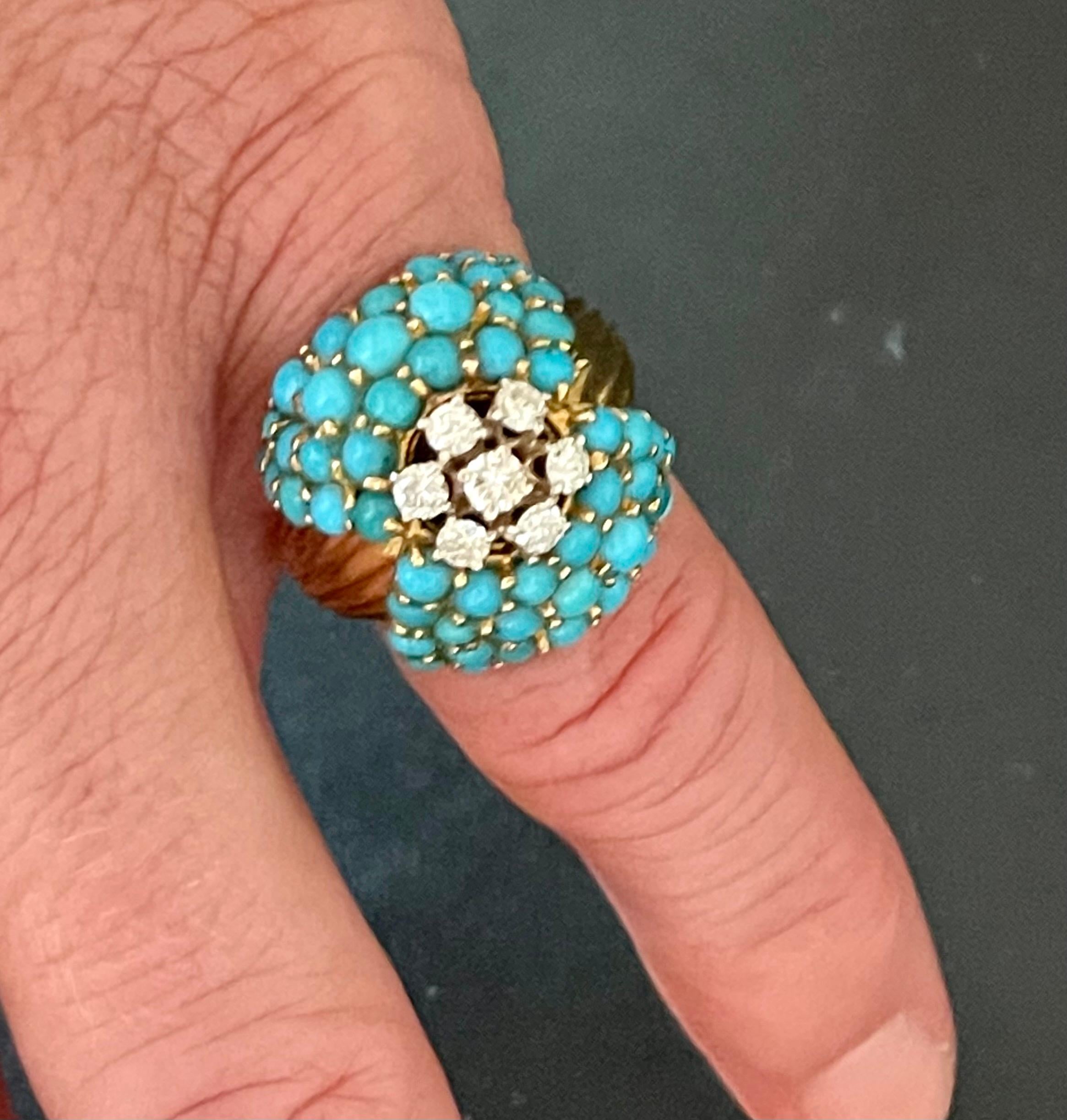 Charming and intricate this 18 K yellow Gold Vintge Cocktail Ring set with natural Turquoise Cabochins and 7 round brilliant cut Diamonds weighing approximatly 0.70 ct. 
Dimensions: 1.84 cm x 2.04 cm 
The ring is currently size 53/13 (US size 6 1/2)