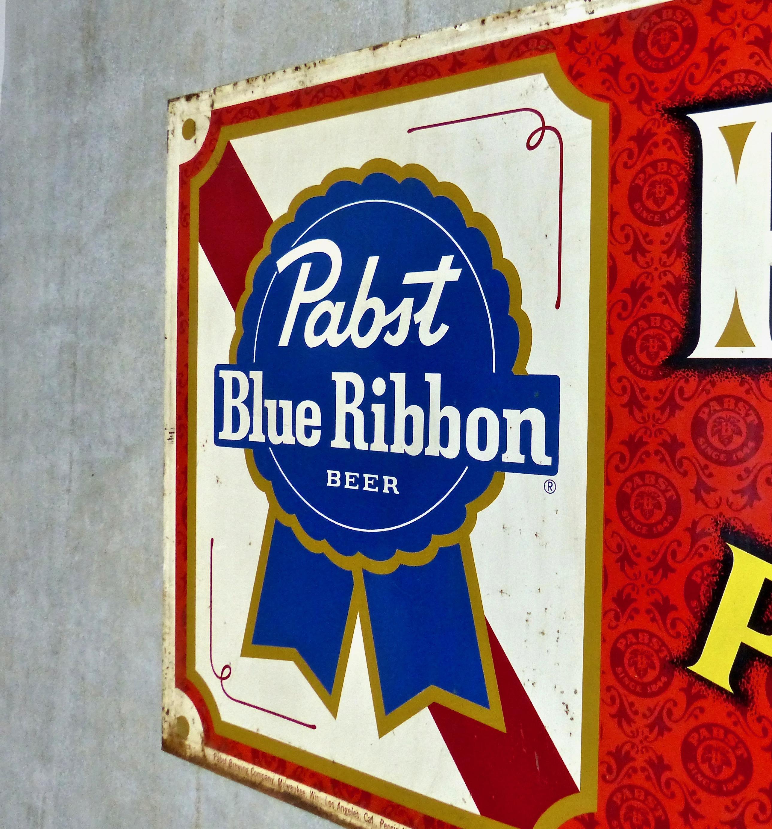 A big and bright Pabst blue ribbon metal beer sign, circa 1950. Great colour and period style. Some rust on the edges, but overall, a great piece of advertising art for a pub or man cave.
Dimensions: 46 H” x 100 W”.
   