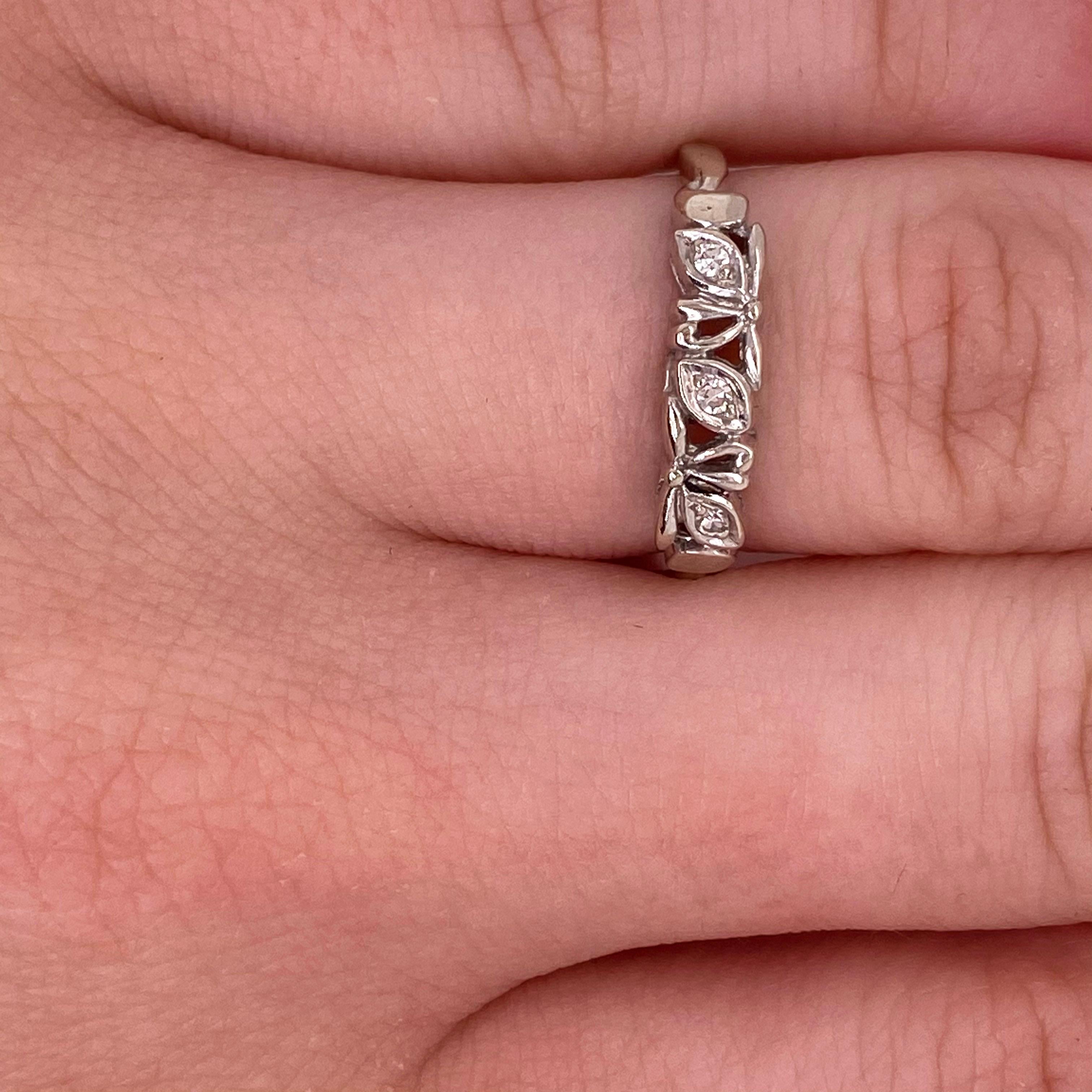 This 1950’s diamond band looks great for a wedding band or as a ring for any finger.  The leaf design is very unique and has three diamonds on it. The band is delicate enough to look good with most engagement rings. The details for this beautiful