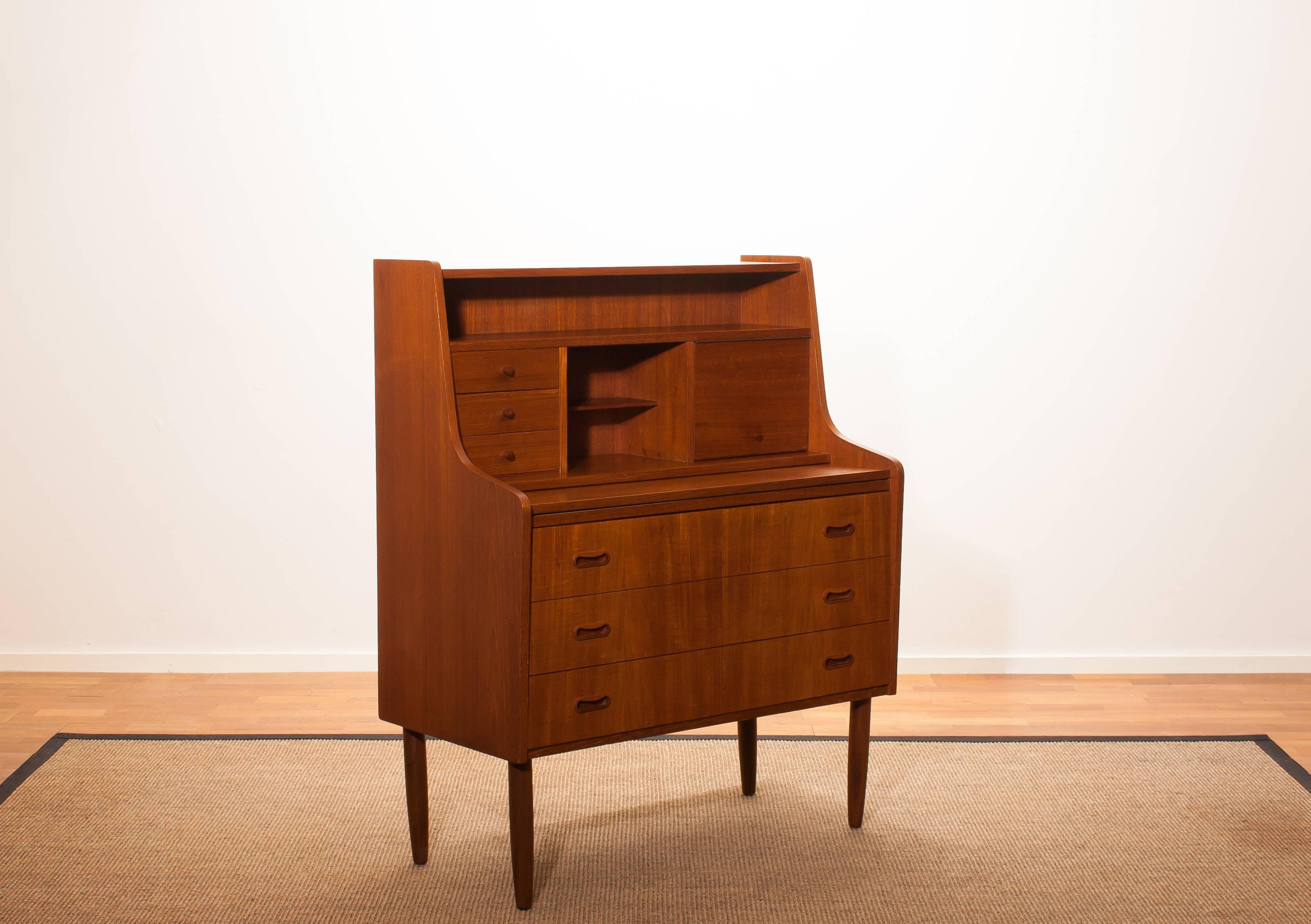 Beautiful secretaire or dressing table in the style of Peter Hvind.
The secretaire is made of teak and has a lot of storage space, an extendable writing space and a mirror.
It is in a wonderful condition.
Period 1950s 
Dimensions: H 110 cm