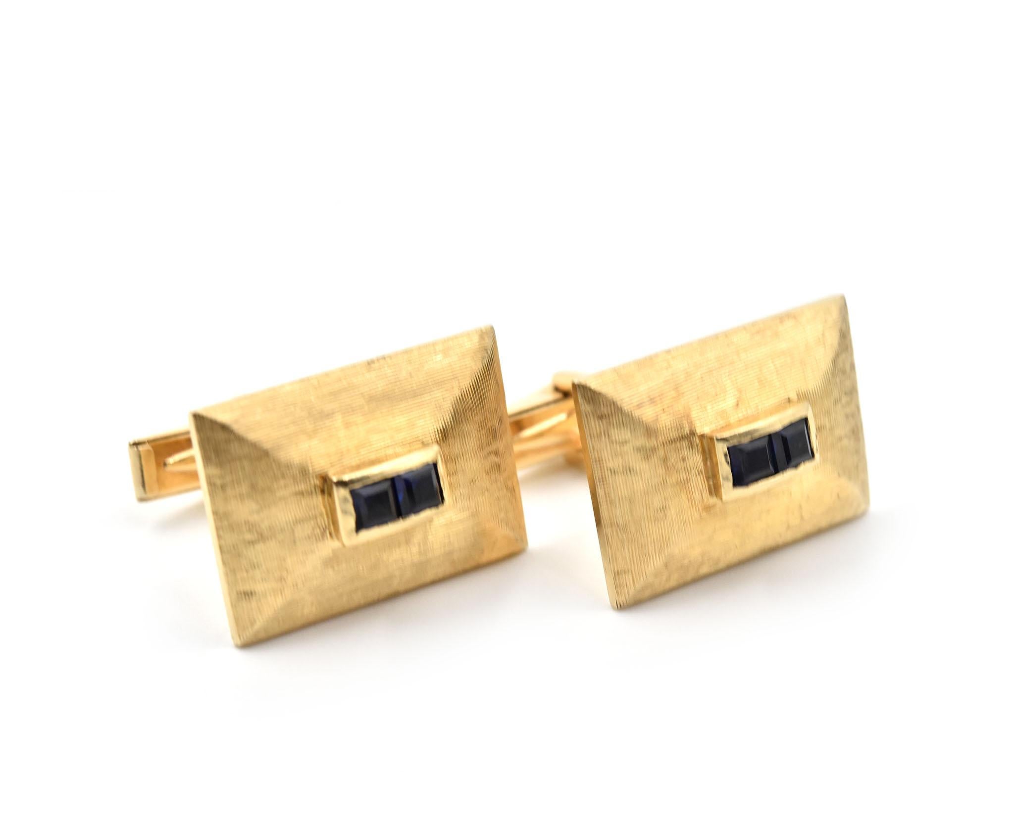 Designer: custom design
Circa: 1950s
Material: 14k yellow gold
Sapphire: four square cut = 0.36 carat weight
Dimensions: each cufflink is 1/2-inch long and 7/8-inch wide
Weight: 11.40 grams
