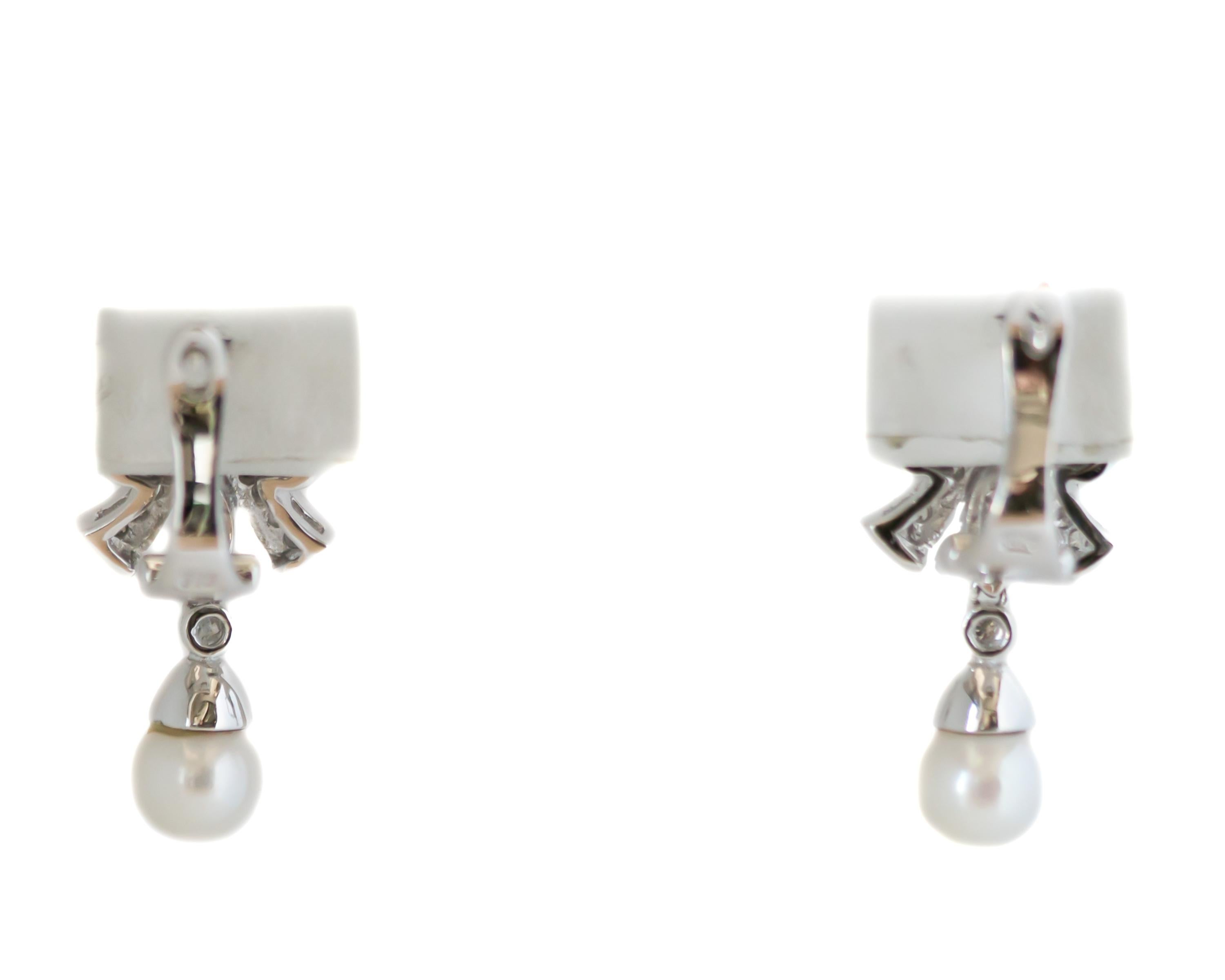 1950s Retro Diamond Chandelier Earrings - 14 Karat White Gold, Diamonds, Pearls

Features: 
0.80 carat total Round Brilliant Diamonds
6.5 millimeter cultured Pearls (Quantity 2)
14 Karat White Gold Setting
Hinged Snap Back Posts
Ribbon Bow