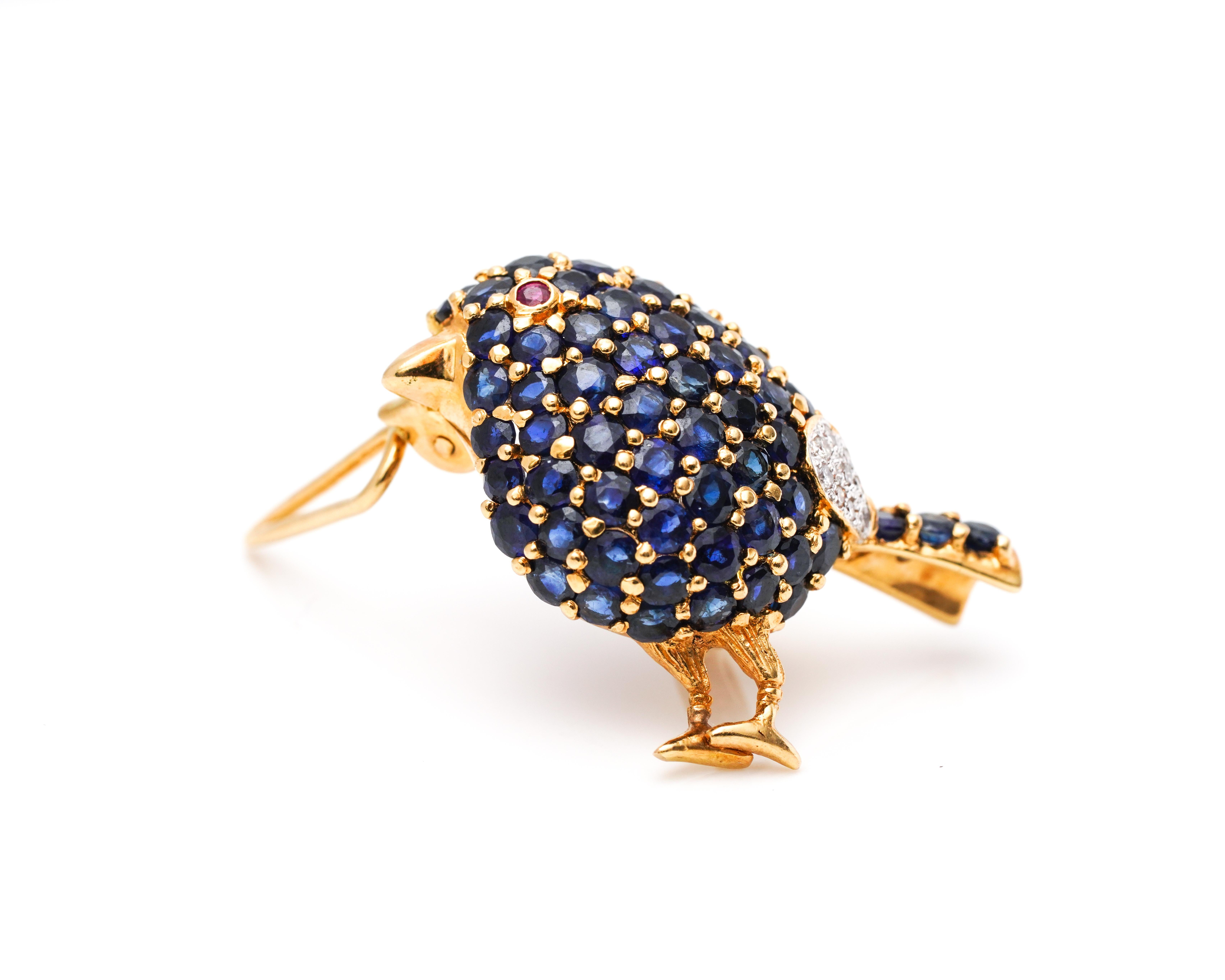 Bird Details:
Metal type: 18 Karat Yellow Gold
Weight: 7.5 grams

Features 1 Carat of Sapphires, Natural Blue in Color (body)
Features Accent Ruby (eye) and Diamonds (near the tail) 
Dates back to 1950s