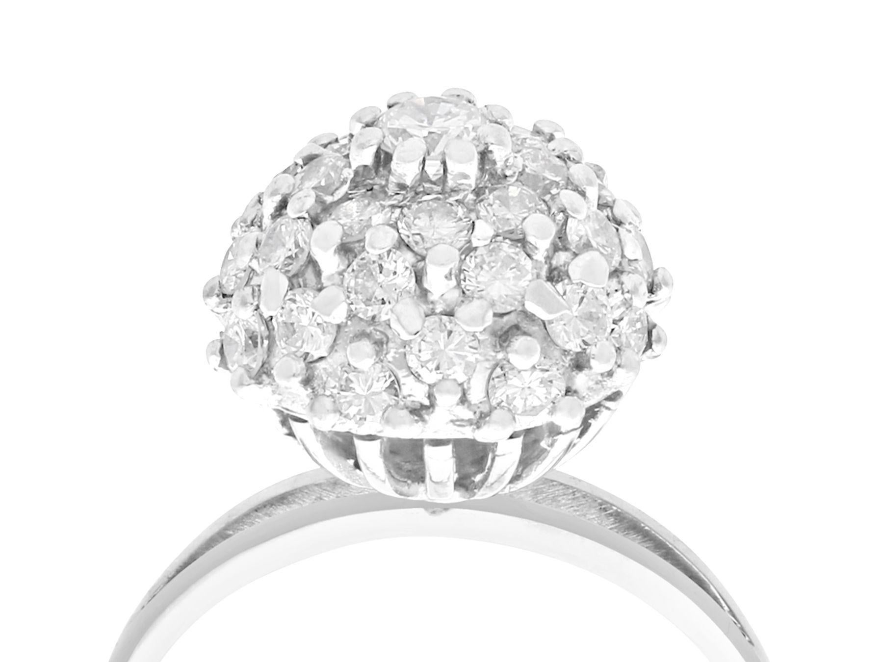 A fine and impressive vintage 1.07 carat diamond and 18 karat white gold cluster ring in the Art Deco style; part of our diverse vintage jewelry collections.

This fine and impressive vintage 1950s diamond cluster ring has been crafted in 18k white