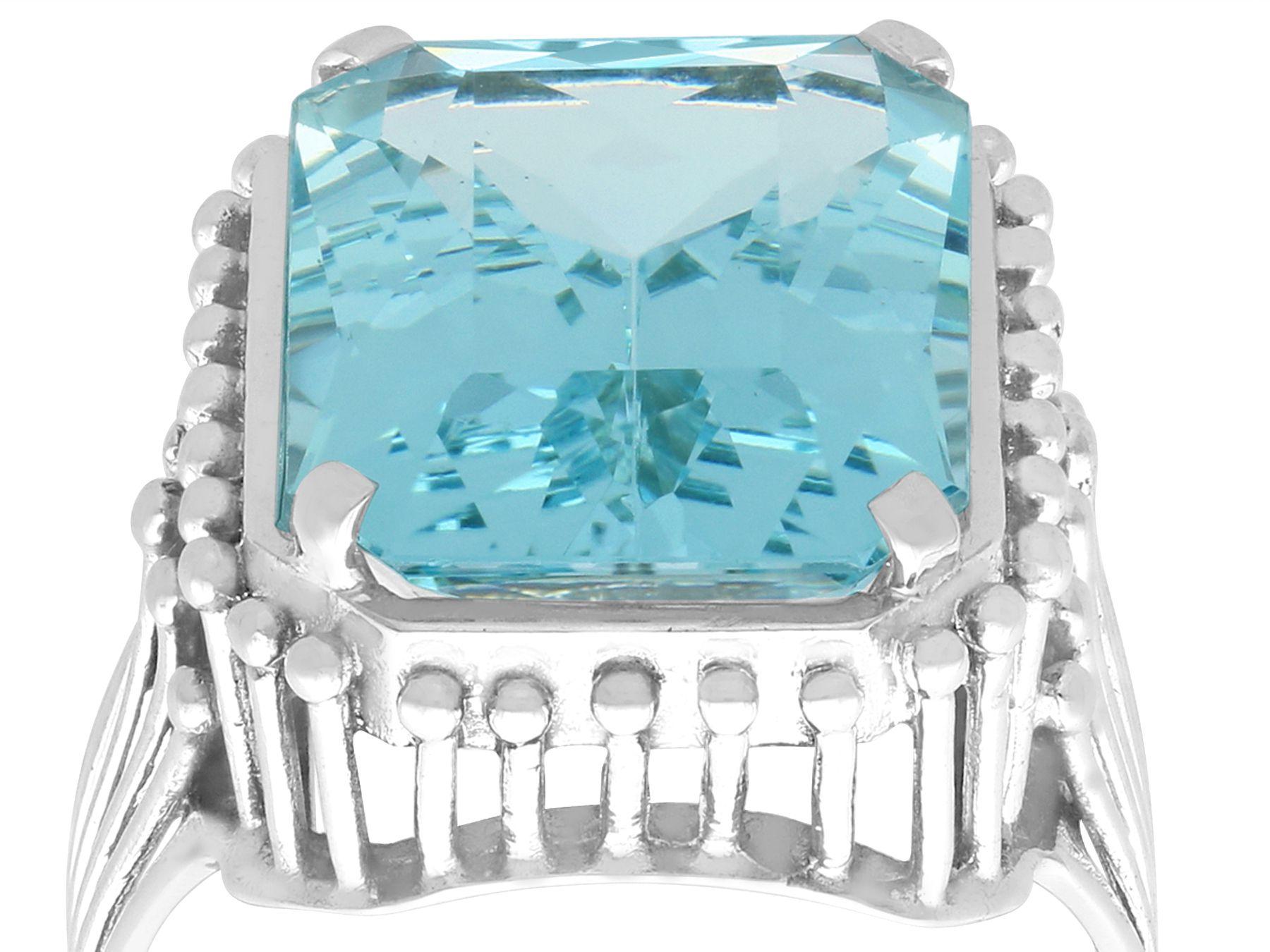 A stunning vintage 1950s 11.81 carat aquamarine and platinum cocktail ring; part of our diverse gemstone jewelry and estate jewelry collections

This stunning, fine and impressive vintage emerald cut aquamarine ring has been crafted in