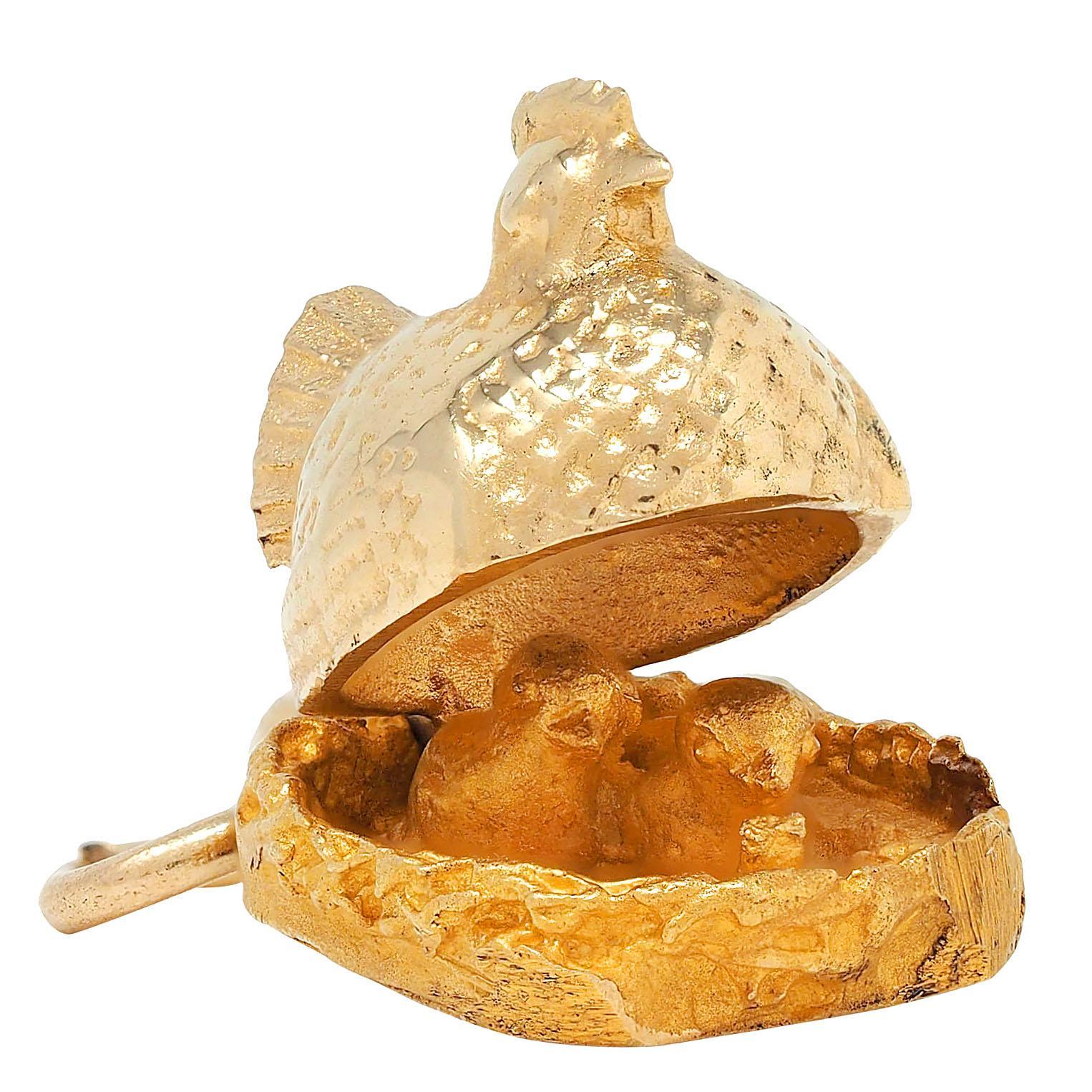 Designed as a highly rendered mother hen sitting in a nest
Grooved with detail throughout and hinged to open
Revealing two chicks in a nest
Bottom of nest is inscribed 