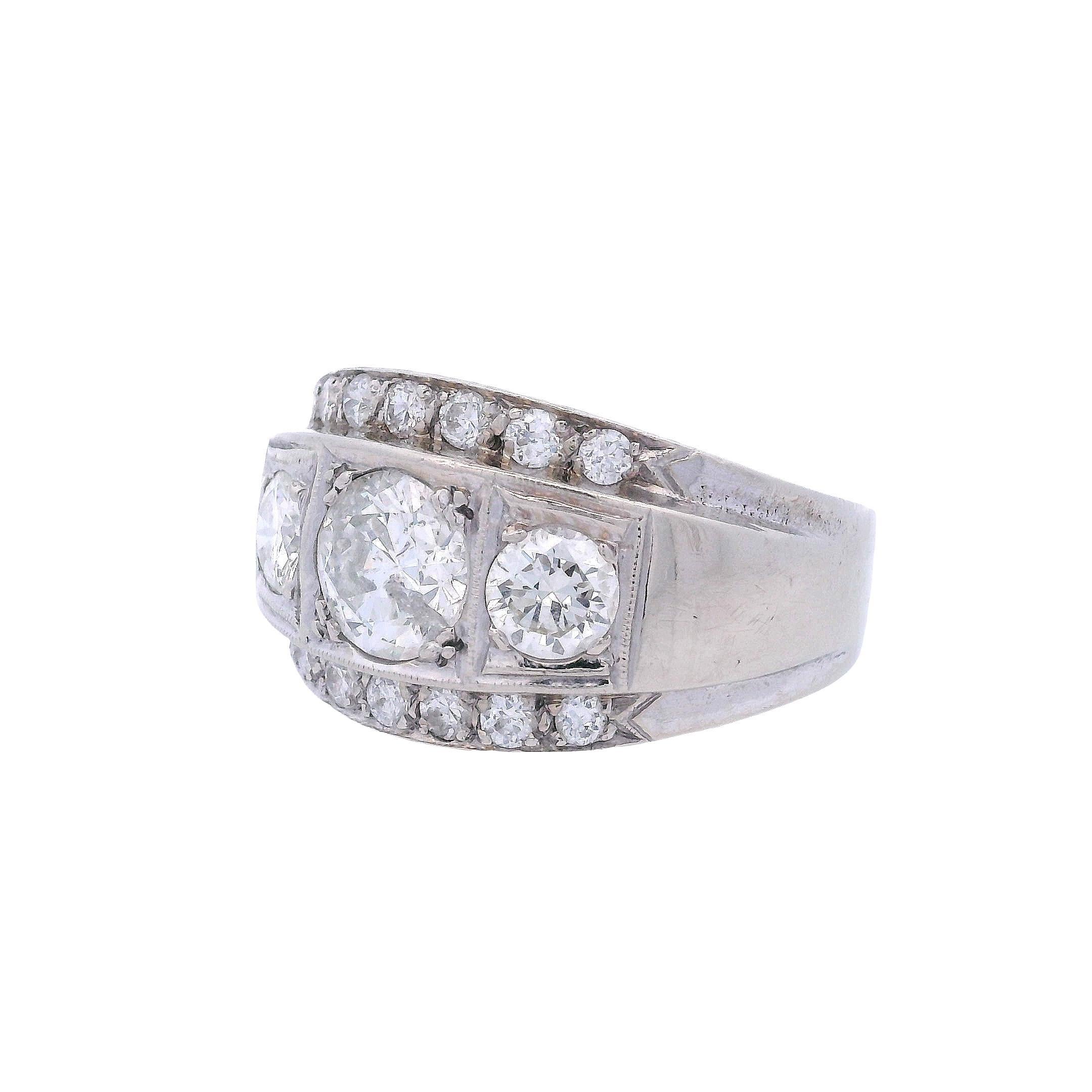 This stunning 1950's engagement ring showcases the romantic charm of European-cut diamonds in a classic three-stone design with accent diamonds. Crafted in elegant 14kt white gold, this timeless piece features 15 European-cut diamonds that display