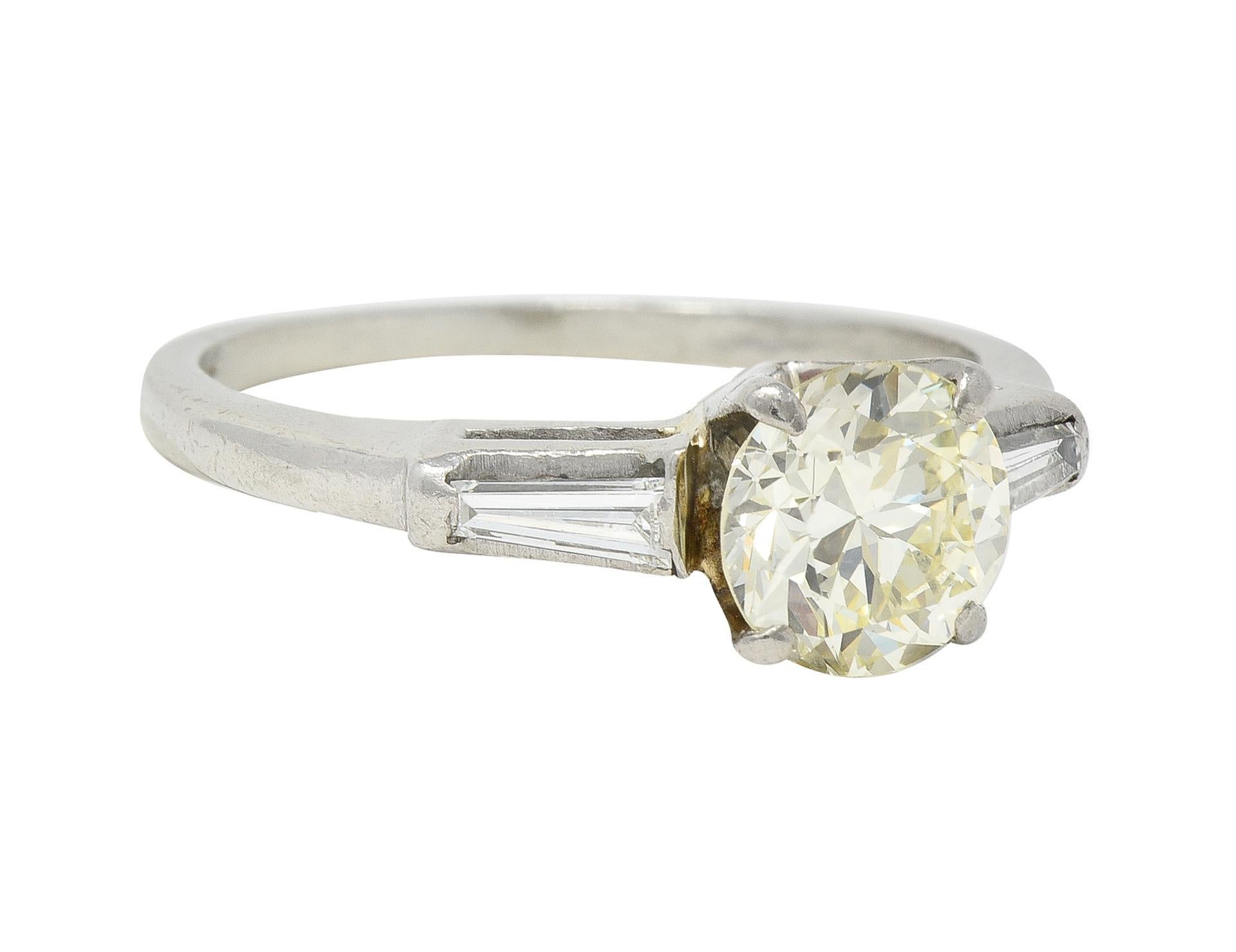 Featuring a transitional cut diamond weighing approximately 1.25 carats - O/P color with VS1 clarity
Flanked by cathedral shoulders bar set with tapered baguette cut diamonds
Weighing in total approximately 0.25 carat with H/I color and VS