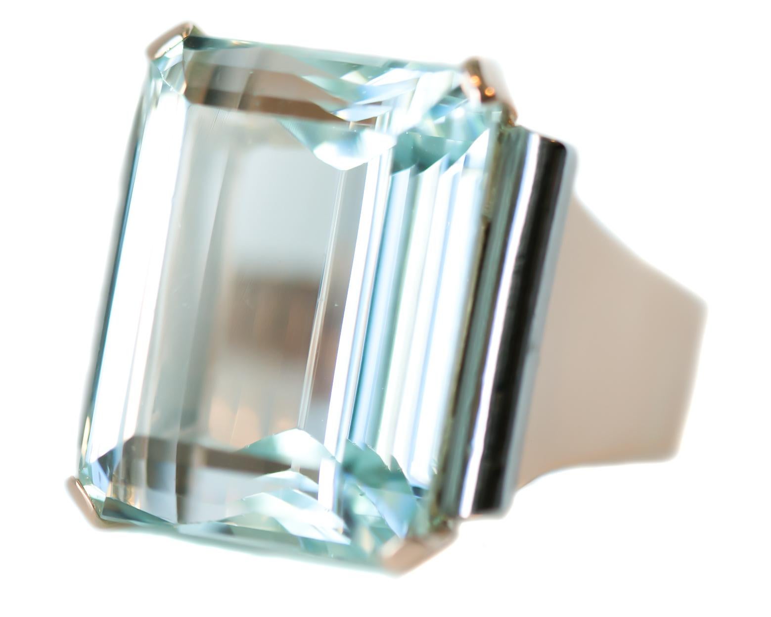 1950s Retro 18 Carat Aquamarine Ring -  14 Karat Rose Gold, Aquamarine

Features: 
18 Carat Emerald Step Cut Aquamarine 
14 Karat Rose Gold Setting
Rolled Scroll Style Setting Sides
Cathedral Setting
Open Cut Out Scroll Design Gallery
Clear, light