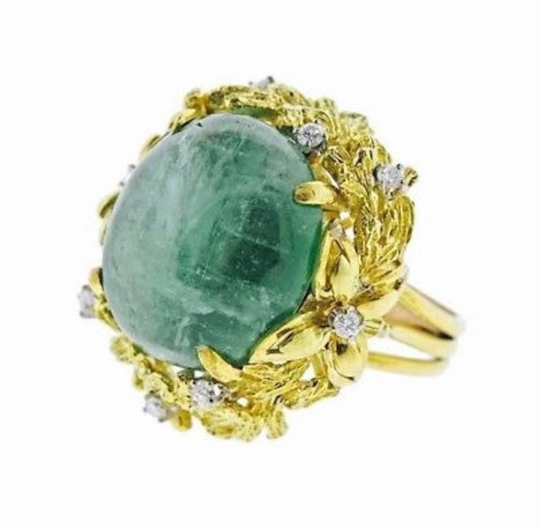 This beautiful 1950's estate ring is comprised of an 18k gold floral leaf setting with 0.70 carats of brilliant white diamonds and a lovely large green emerald cabochon measuring 18.6 x 17.4mm.  The ring size  is a 5.5 (with sizing shank) and can be