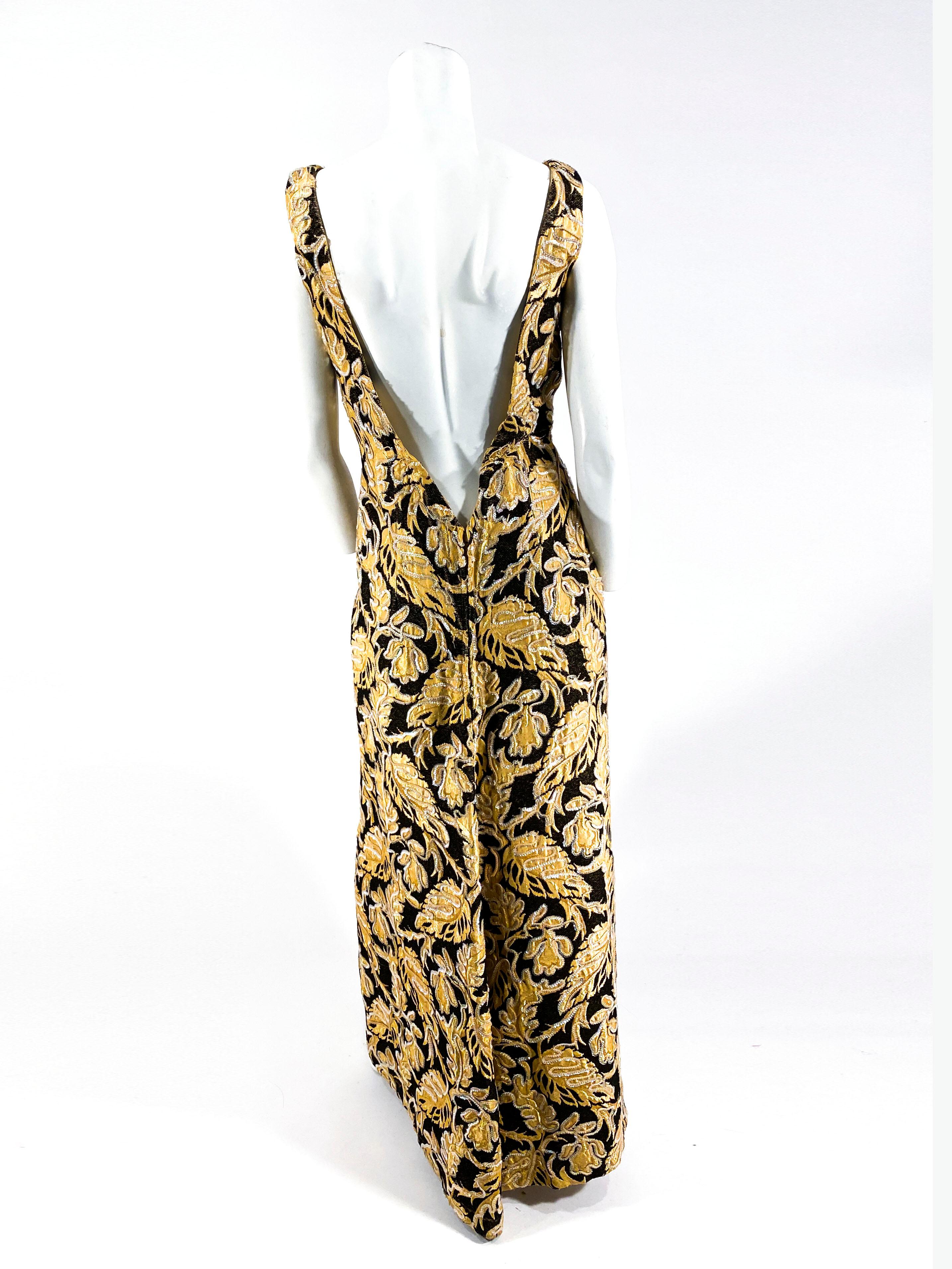 Custom made late 1950s to early 1960s gold and black chenille foliage tapestry gown with a semi-plunge neckline and an extremely low plunge backline going down to the was it. The entire dress is decorated with an iridescent sequin soutache. The