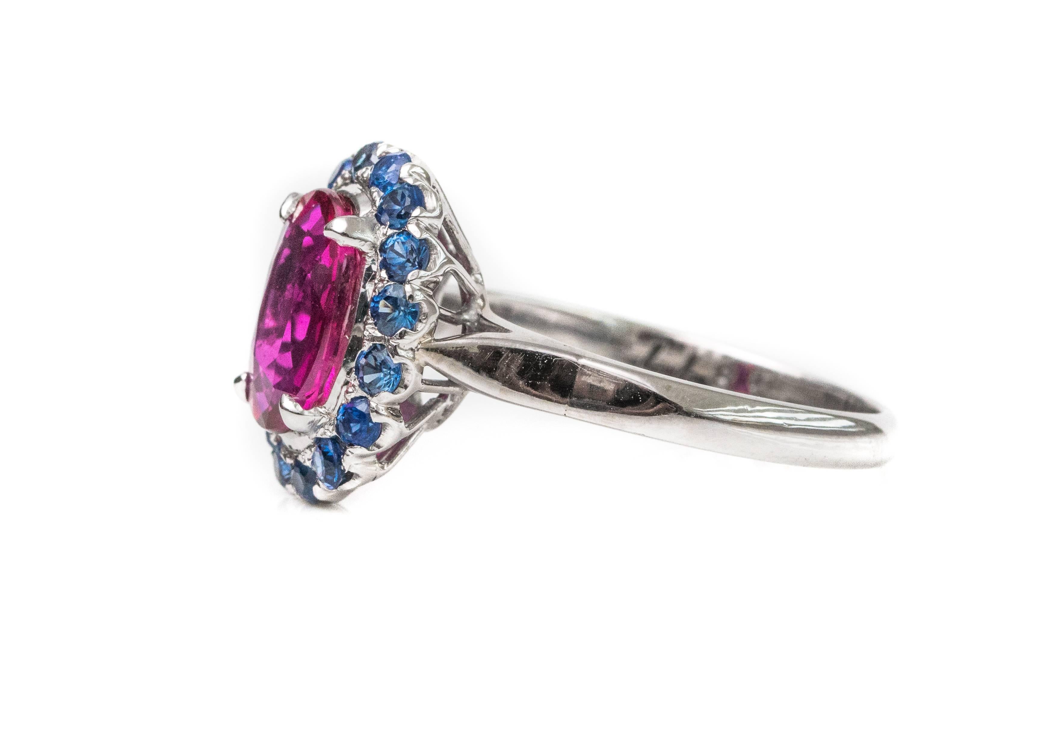 1950s 2 Carat Burma Ruby with Ceylon Sapphire Halo Ring - 14 Karat White Gold

Features a 2.0 carat oval Burma Ruby center stone, Ceylon Sapphire Halo and 14 Karat White Gold. The untreated, pink-red Burma Ruby center stone is prong set. It is