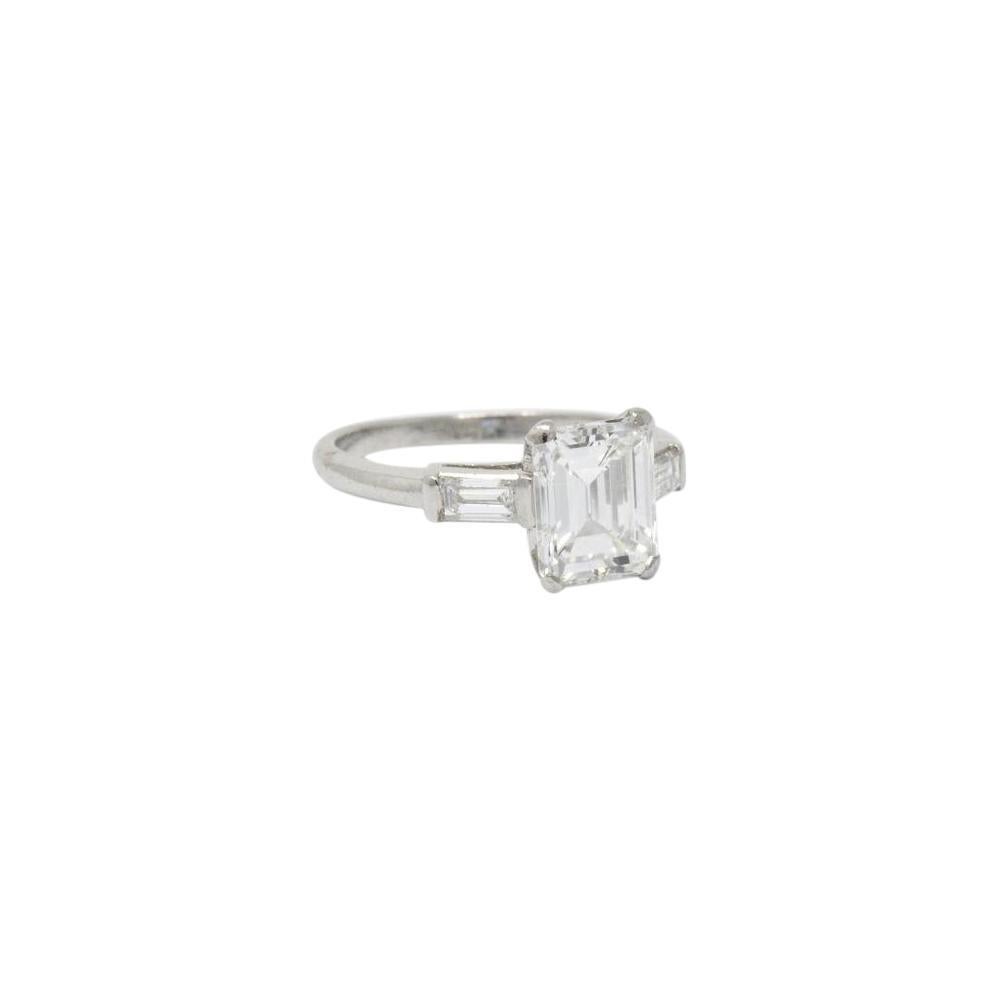 Centering a clean bright white emerald cut diamond weighing 1.86 carat, G color and VVS2 clarity

Two baguette diamond accents weighing .15 carats each

Top measures 8.7 mm and sits 6.1 mm high

Tested as platinum

Ring Size: 5 & Sizable

Total