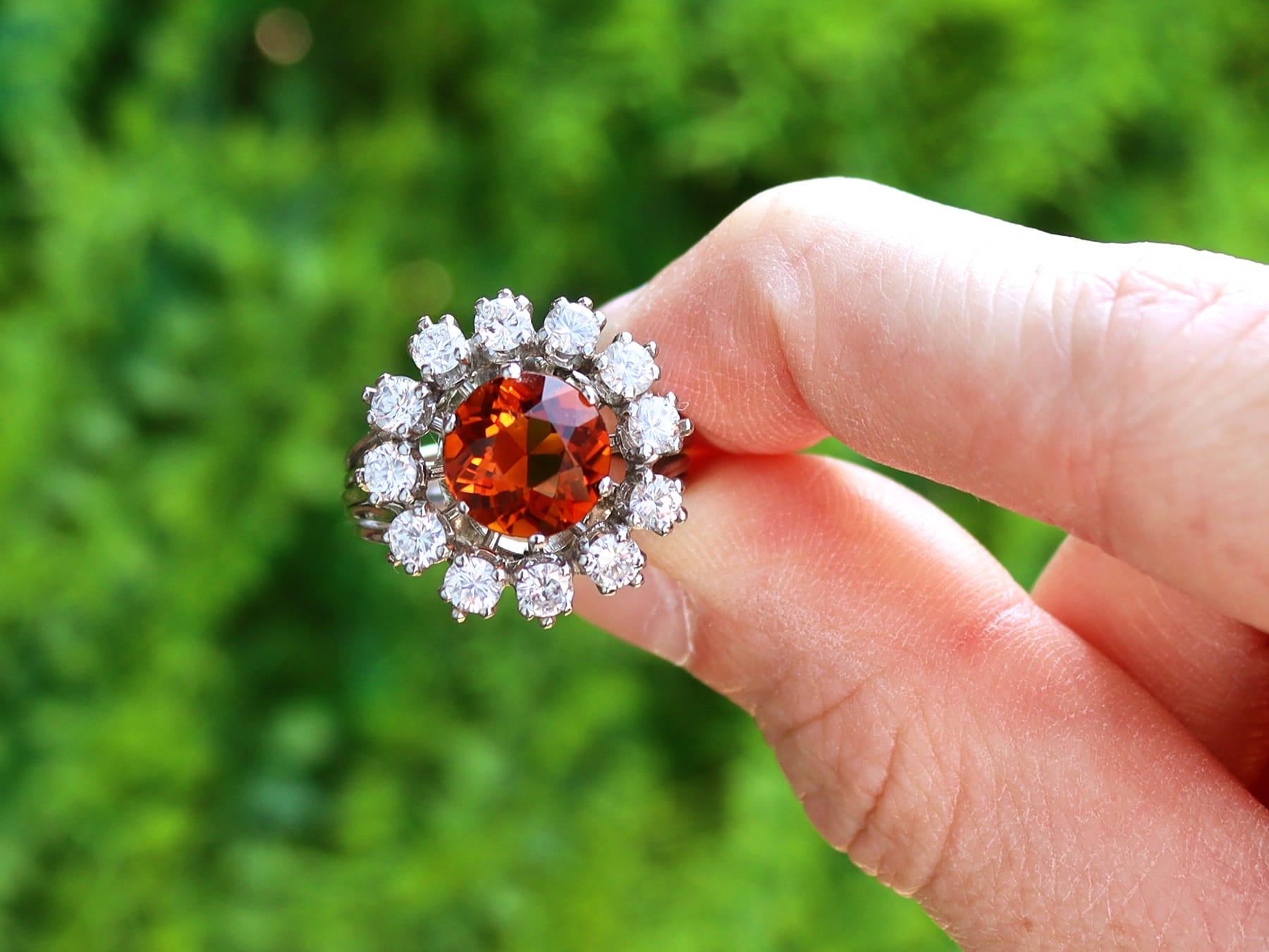 This stunning, fine and impressive vintage gemstone ring has been crafted in platinum.

The pierced decorated, cluster setting displays an impressive central six-claw set 2.83ct round faceted citrine.

The feature stone is encompassed with twelve