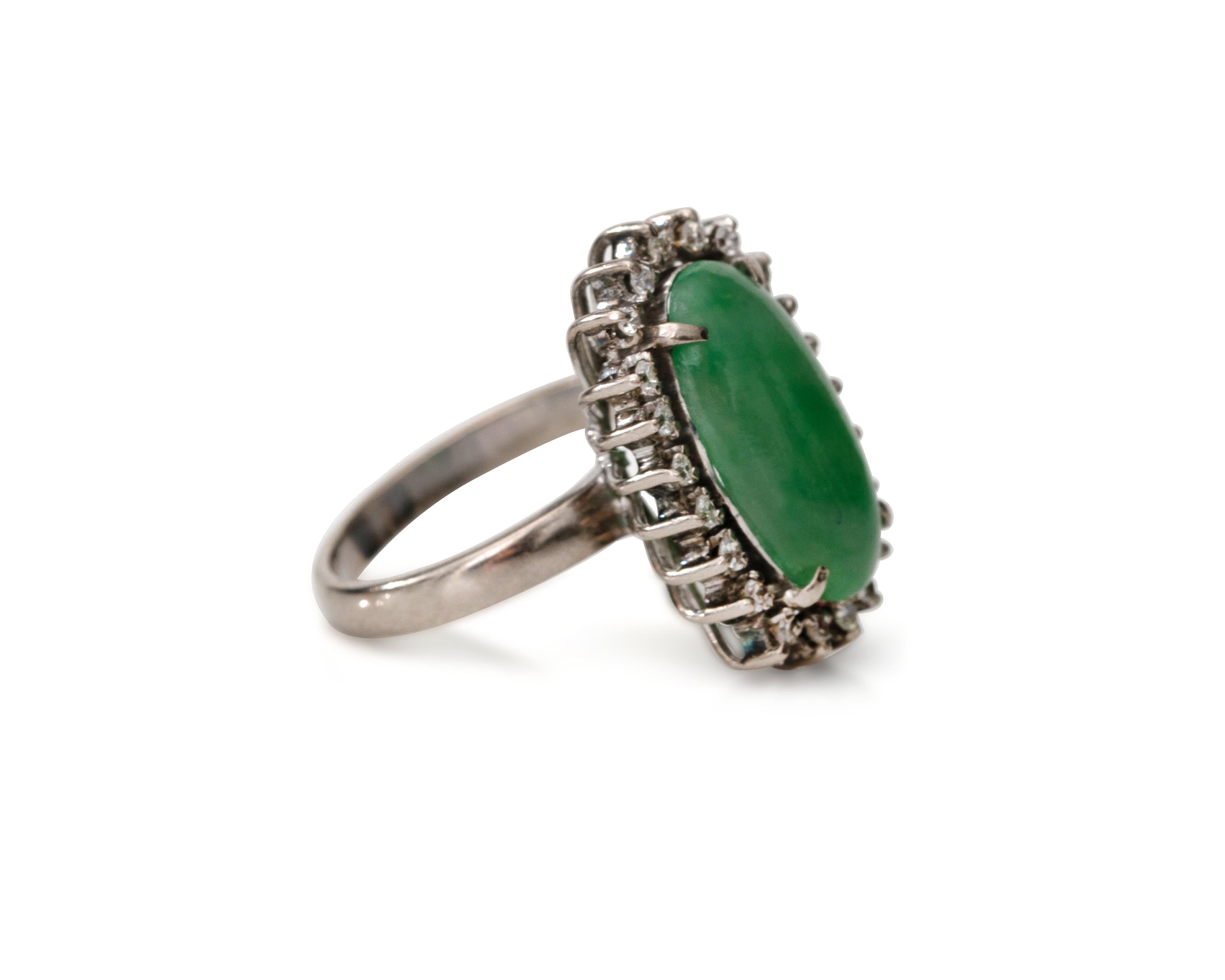Stunning 1950s vintage Jade and Diamond Ring. The Jade is a beautiful oval cut cabochon with lovely hues of green. It has 4 talon prongs holding it in place. The Diamonds are all prong set and complement the perfect sparkle to the Jade

Ring