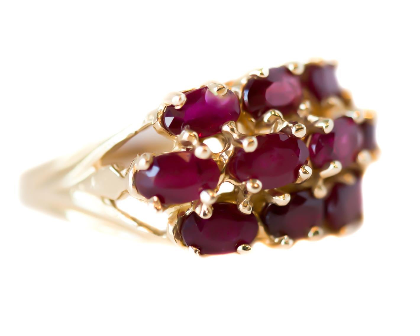 1950s Retro Ruby Cluster Cocktail Ring - 14 Karat Yellow Gold, Rubies

Features:
3.0 carats total Oval cut Rubies (Quantity 10)
Pinkish Red Rubies
14 Karat Yellow Gold 
Prong Set Stones

Finger to top of stone measures 8 millimeters
Ring width