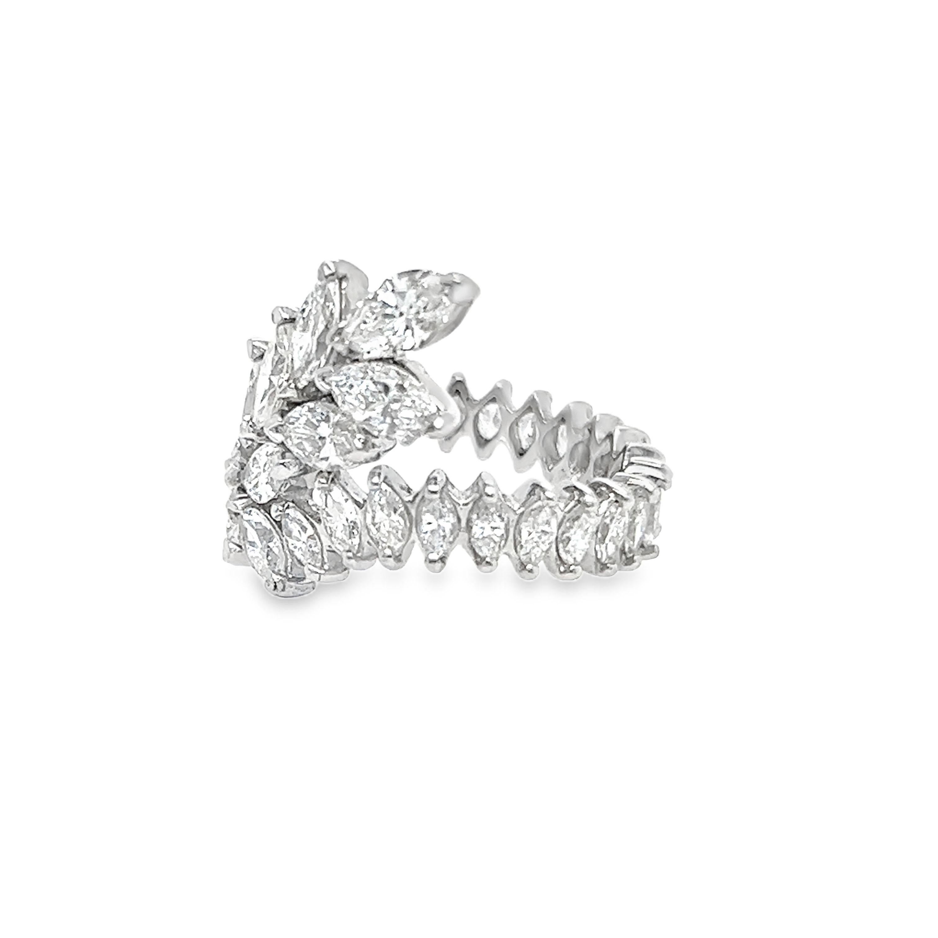 Indulge in the opulent allure of a 1950s marquise diamond eternity band exquisitely crafted in platinum. Delight in the brilliance of each diamond, radiating with E-F color for a captivating display of light. With a minimum of VS clarity, these