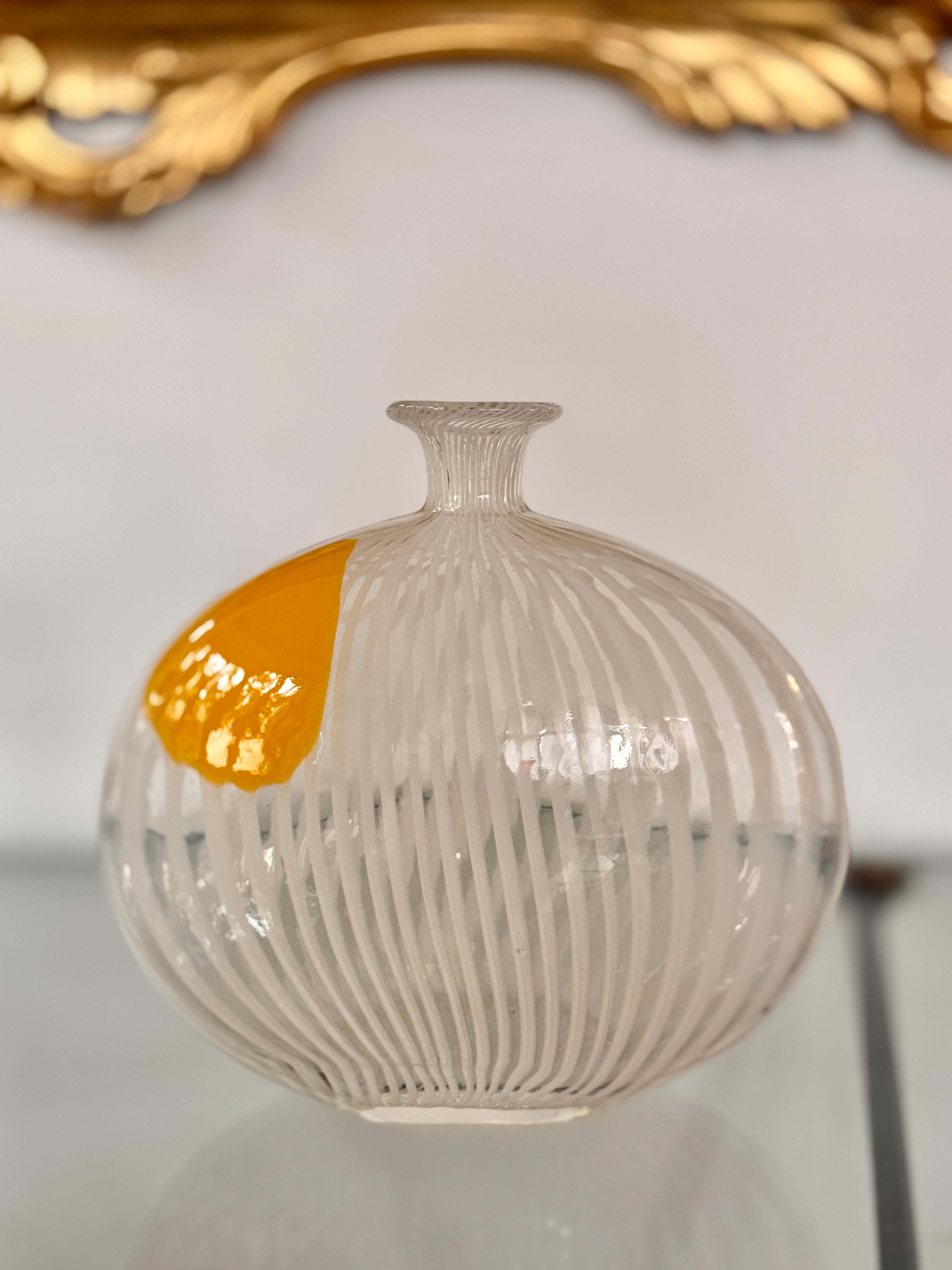 Murano Filigrana “Pillow” Vase, c. 1950–60 attributed to Dino Martens (Aureliano Toso)

Beautiful mid-century modern vintage Murano filigrana vase in a flattened pillow form with a flared neck. Clear crystal encases white canes punctuated by a