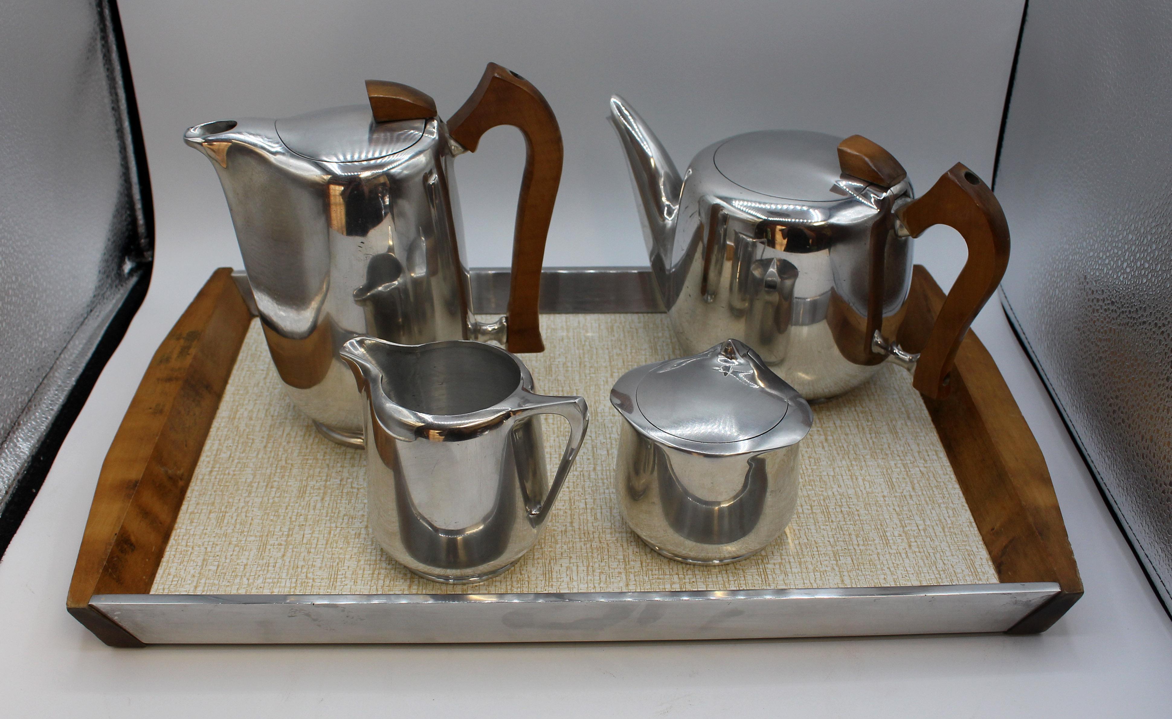 1950s-60s Picquot Ware tea & coffee set with tray. Made in England. Aluminum with shaped wood handles. Great mid century modern design! Tea pot, coffee pot, creamer, lidded sugar & tray. Tray: 18 5/8
