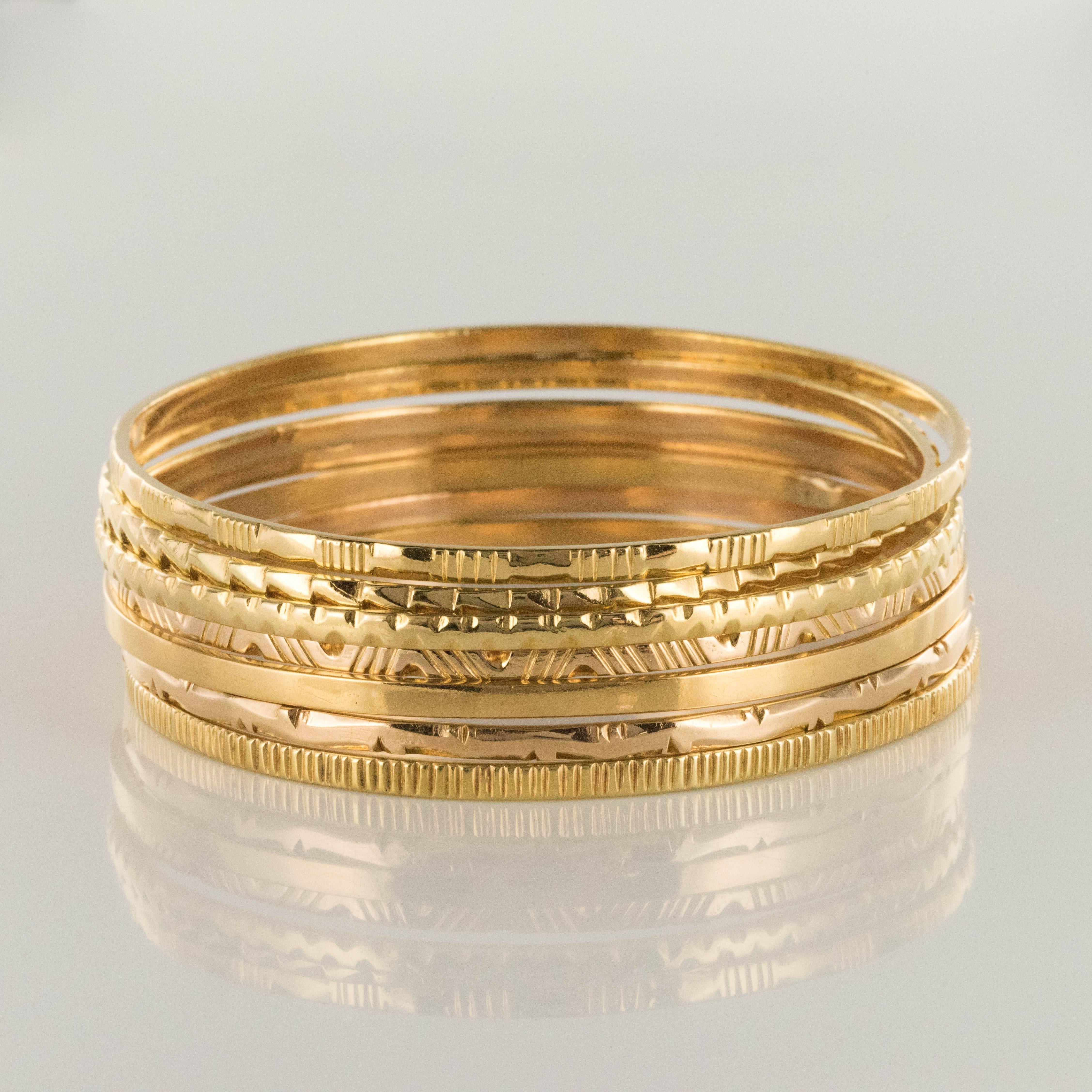 Bracelet in 18 karats yellow gold.
This bracelet is made up of 7 round half bangles in yellow gold and engraved each with a different decoration. The bangles can be worn together or separately and slip on.
Inner circumference: 19 cm, width: 2.6 mm,