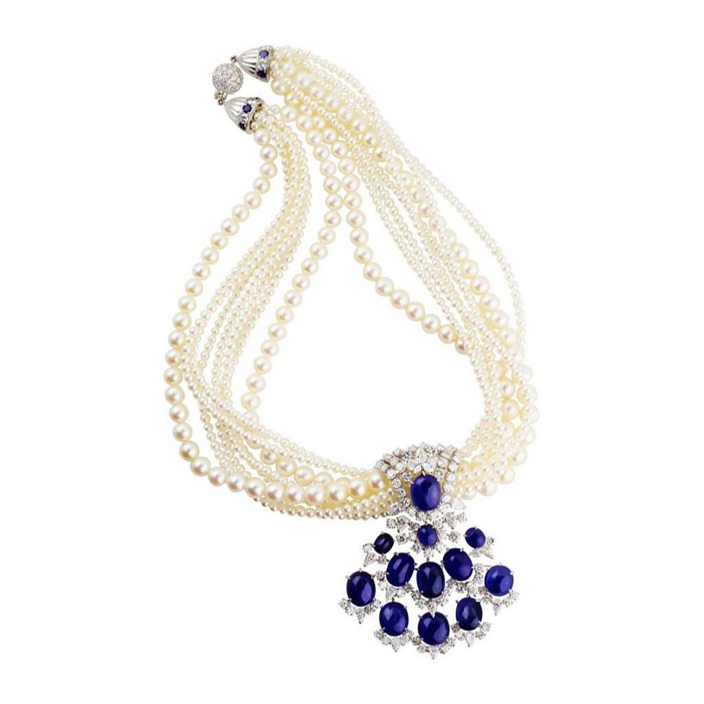 Stunning French necklace estimated to be from the 1950s. Eight strand necklace made up of two strands of 7mm and six strands of 3mm cultured pearls. Detachable enhancer with 12 cabochon sapphires totaling 64.77cts, with 81 round brilliant cut