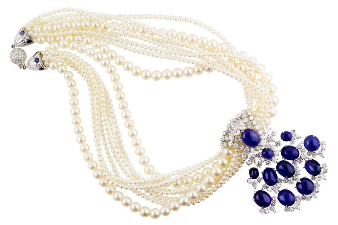 Stunning French necklace estimated to be from the 1950s. Eight strand necklace made up of two strands of 7mm and six strands of 3mm cultured pearls. Detachable enhancer with 12 cabochon sapphires totaling 64.77cts, with 81 round brilliant cut