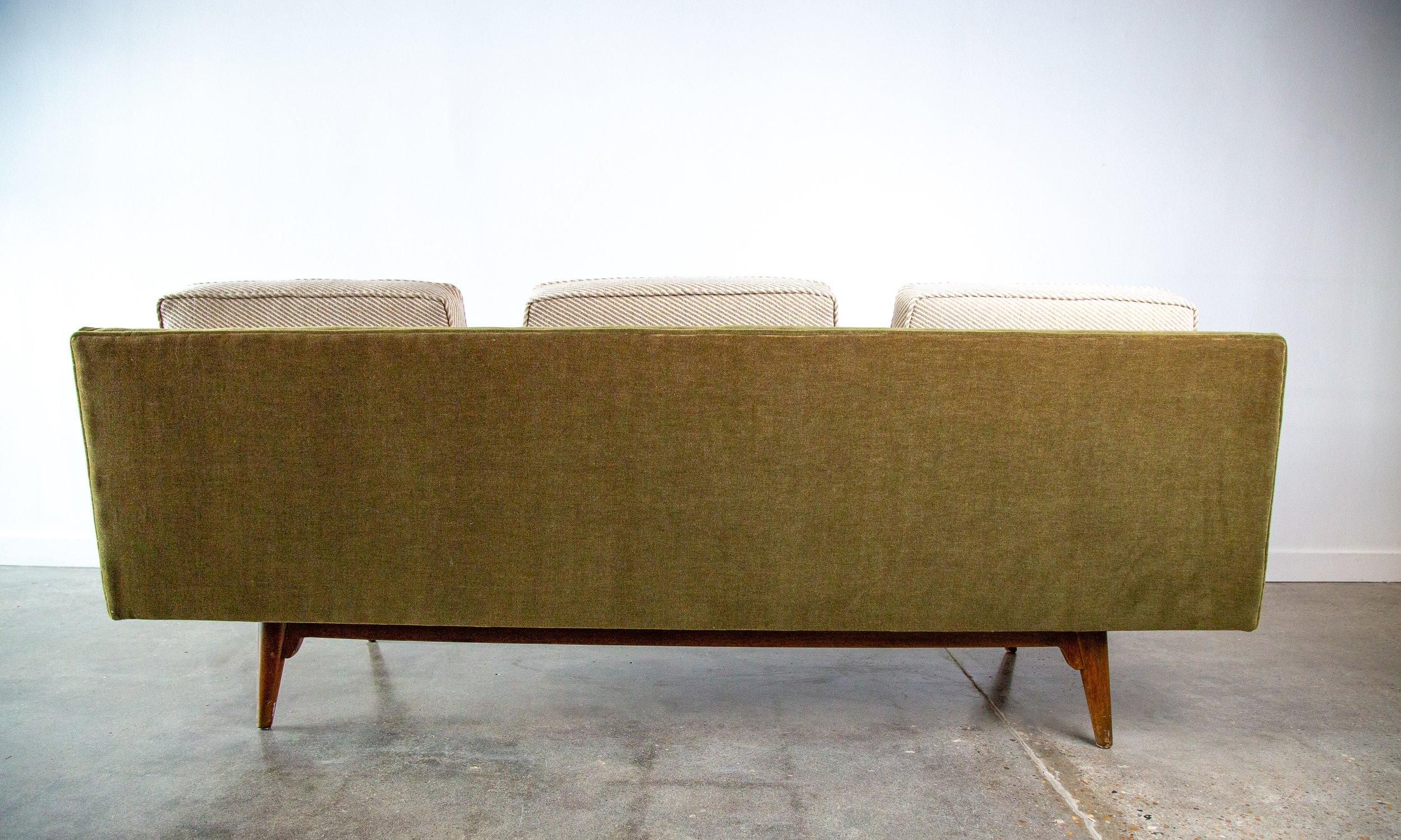 A 1950s iconic armless sofa designed by Edward Wormley for Dunbar Furniture model 5526. Reupholstered in a green mohair base with neutral diagonal striped wool loose cushions.  A very airy form, the sofa looks like its floating on the 4 legs. New