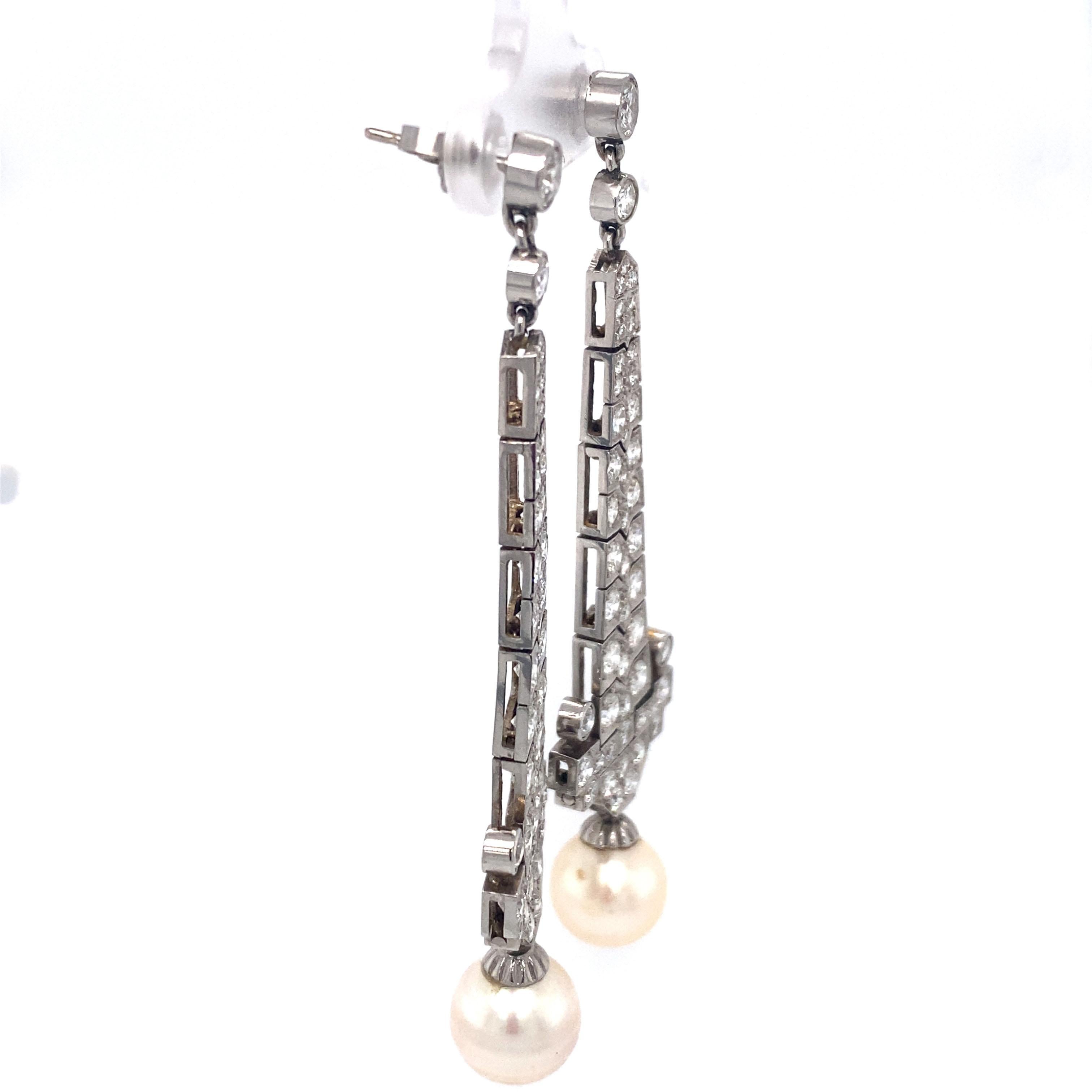 Beautifully crafted 14 Karat White Gold Diamond and Pearl Chandelier Earrings.
These are from the 1950s and pack a lot of style and draw a lot of design from the art deco era. They are very light weight when worn. The sparkling white diamonds are