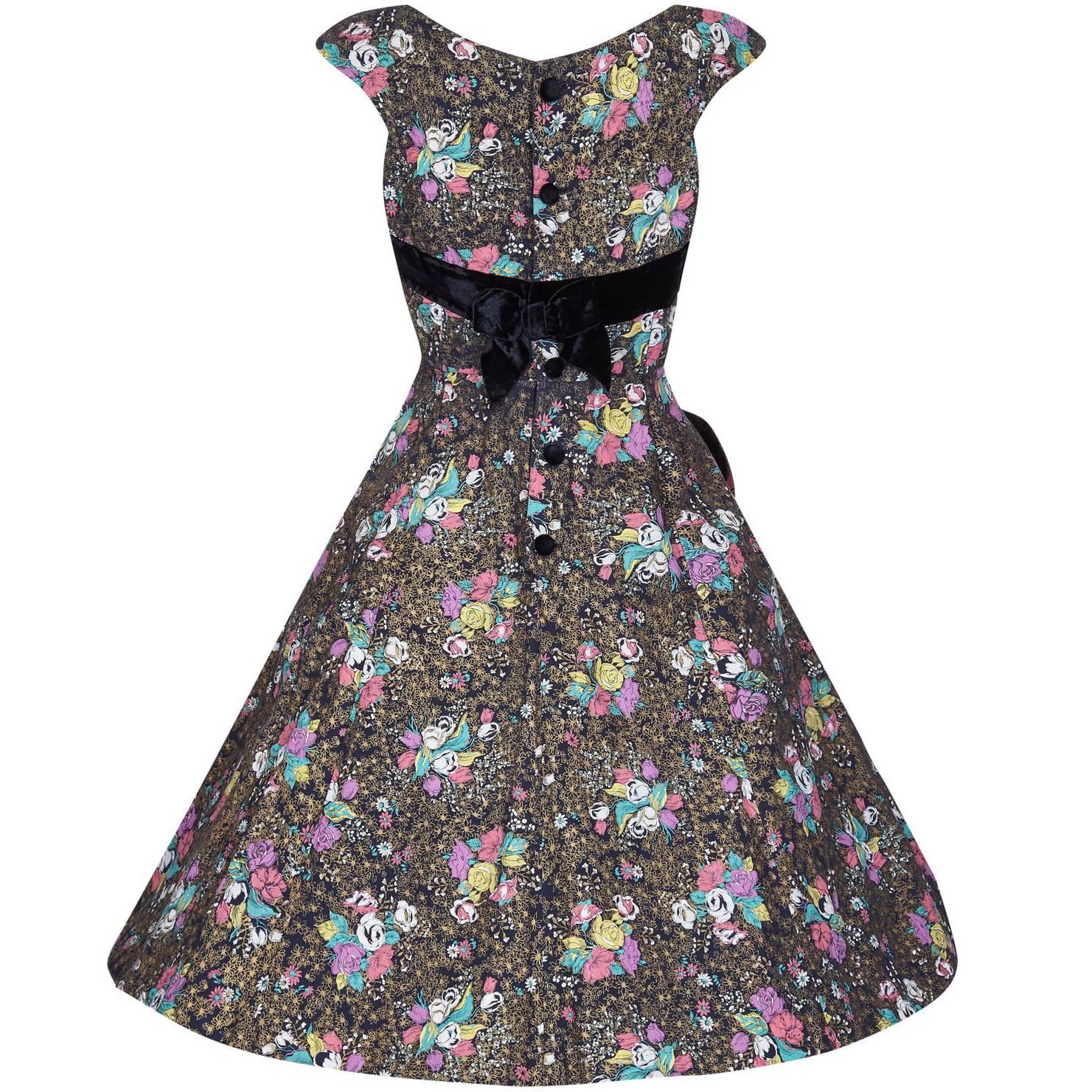 This charming 1950s cotton dress has a print of rose bunches in an assortment of pastel shades - pink, lilac, yellow,  jade green and white, which lie in between beds of gold printed daisies on a black background. The dress has a boat neckline with