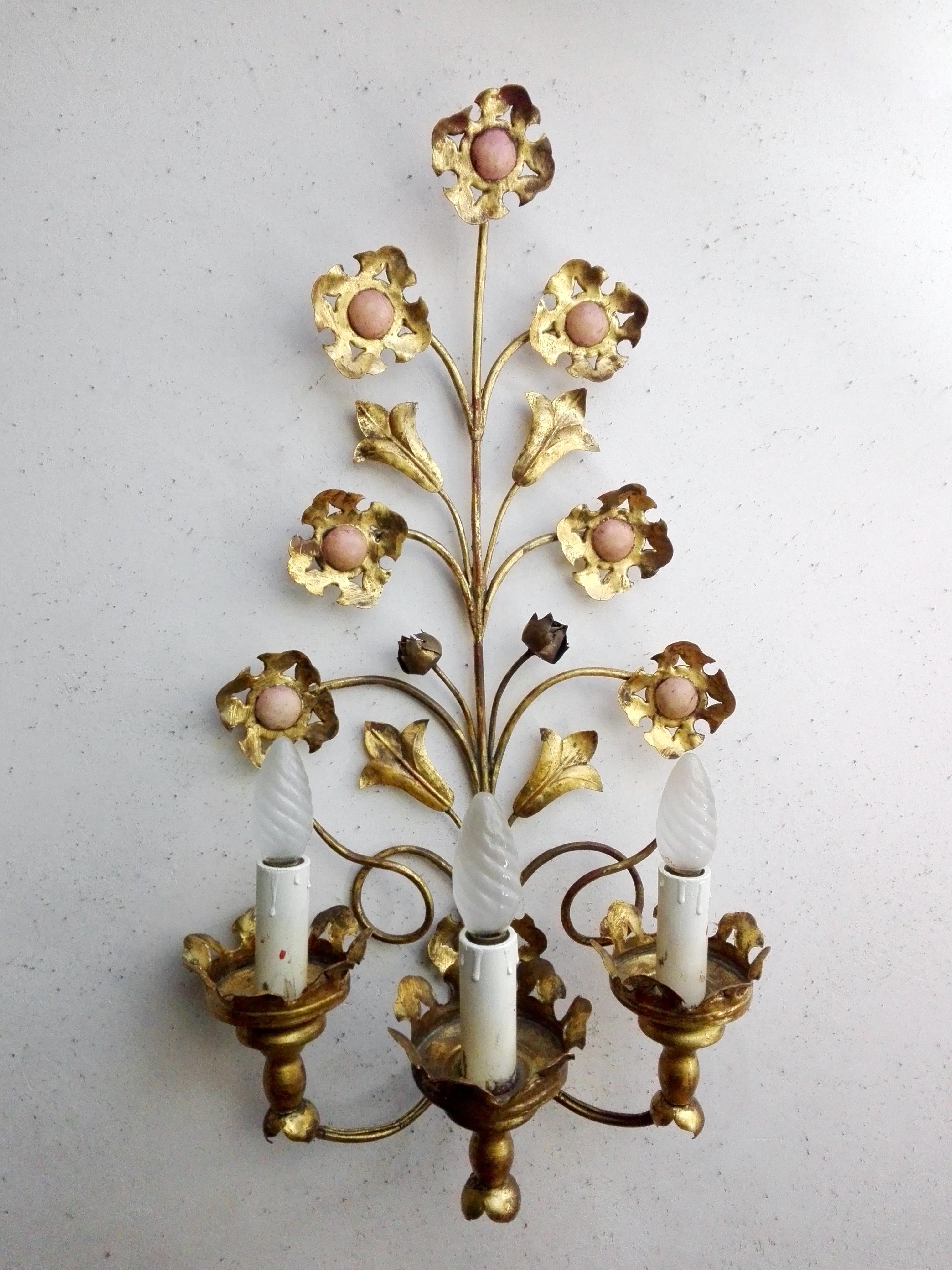 Wonderful Italian 1950s three-light gilt tole wall lamps featuring flowers and leaves in lovely original shape. Traditional Florentine handmade, Hollywood Regency style.
Original wooden candle E14 ( US E12 adaptable) lamp holders.
Bulbs not