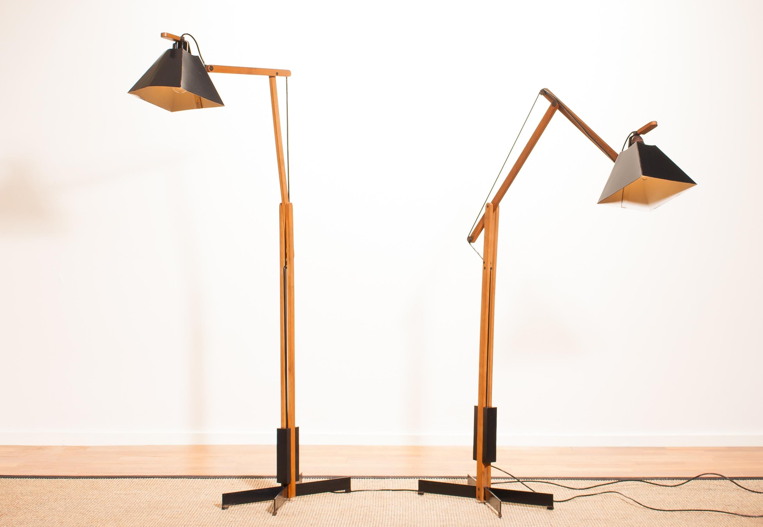 Magnificent rare floor lamps by Luxus, Sweden.
These lamps are adjustable by a counterbalance.
The stands are made of teak with a black lacquered shade.
They are labelled by Luxus and are in a beautiful condition.
Period 1950s.
Dimensions: H